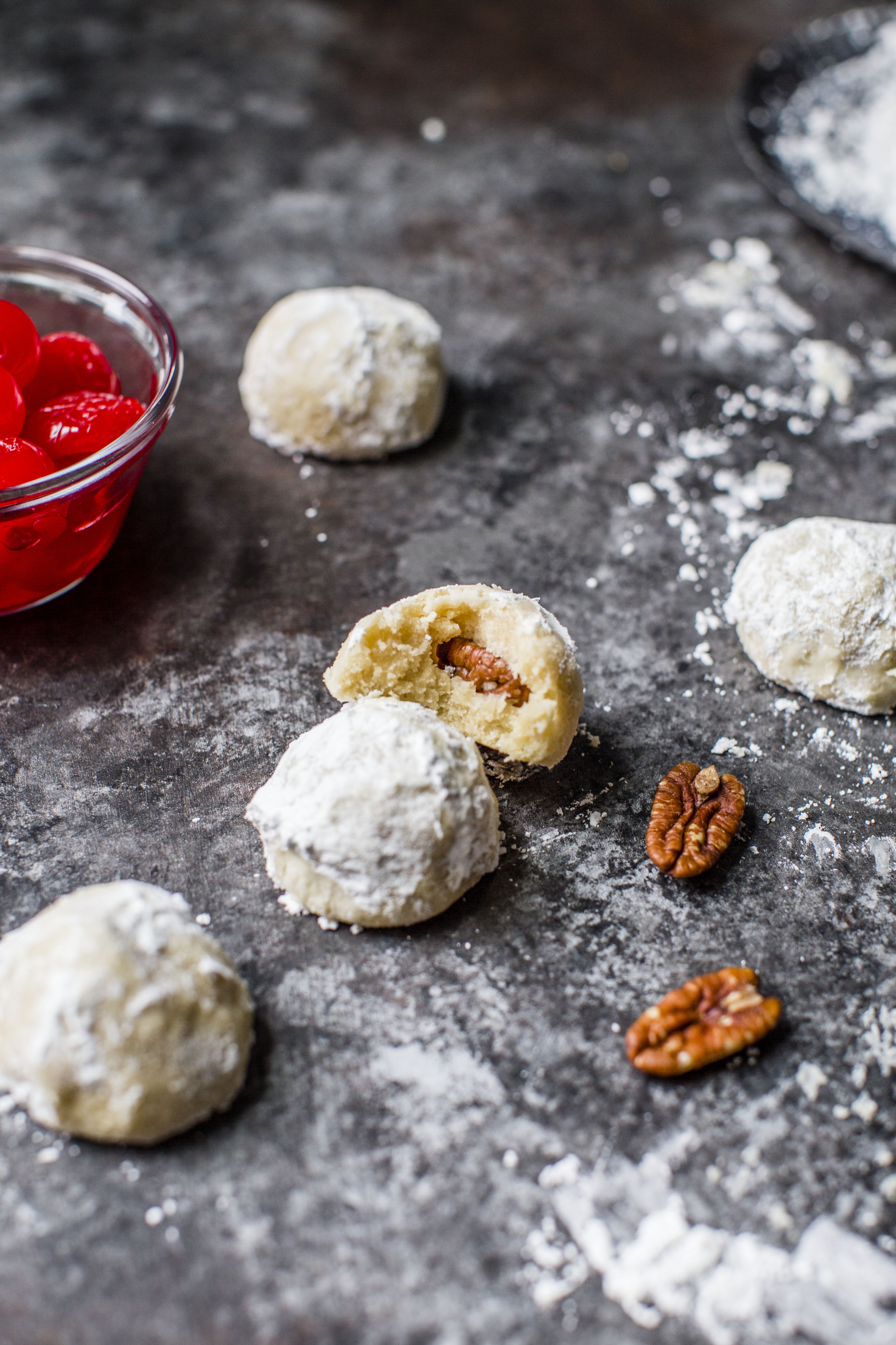 These classic butterball cookies are a favorite that my grandmother made every year at Christmas. They are a light cookie that isn't super sweet and the center is filled with either a pecan or maraschino cherry. Classic and delicious! I howsweeteats.com #butterball #cookies