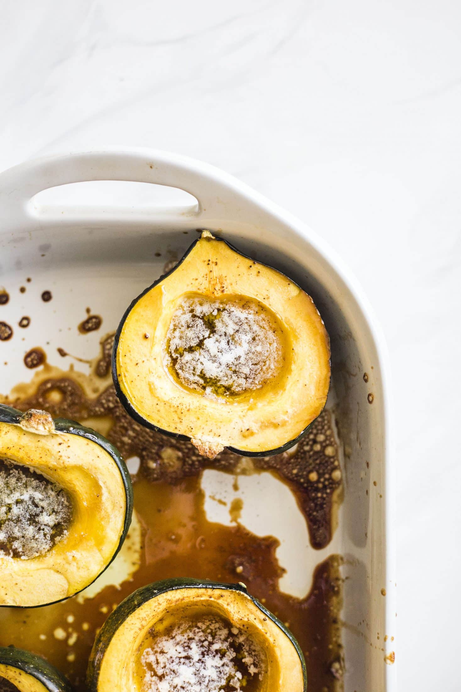 This baked acorn squash recipe is so delicious for the fall! It's made with vanilla and bourbon, finished with balsamic, is super easy, a bit indulgent and perfect for the season. Makes for a fabulous side dish in autumn or even a dessert! I howsweeteats.com #acorn #squash #baked #vanilla #bourbon
