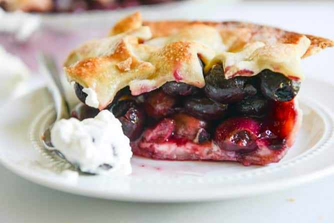 sweet cherry pie with amaretto whipped cream I howsweeteats.com