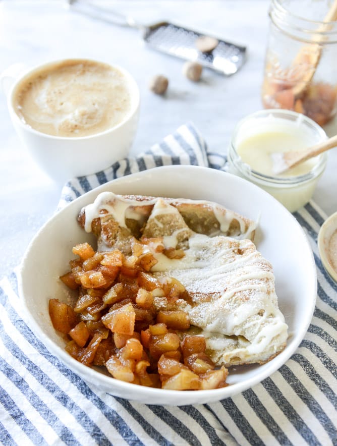 vanilla cinnamon roll dutch baby with apple bourbon compote and cream cheese icing I howsweeteats.com