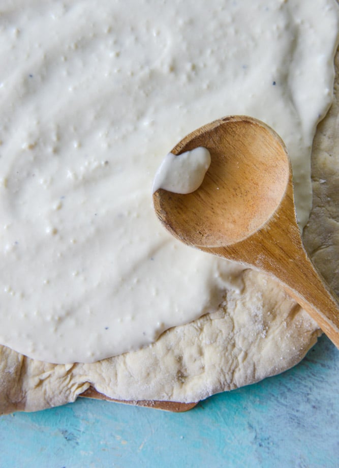 white pizza with garlic sauce and garden herbs I howsweeteats.com