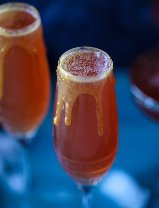 pomegranate cider mimosas with a salted caramel rim I howsweeteats.com #cocktails #thanksgiving #applecider #mimosas