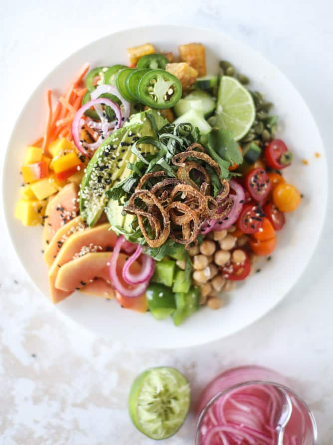 This spicy rainbow salad is chock full of gorgeous, fresh produces, chickpeas, plantains and herbs for one beautiful sight in a bowl. The rainbow salad is satisfying, filling, delicious with a touch of sweet and slightly spicy - everything you want in a meal! I howsweeteats.com #spicy #rainbow #salad