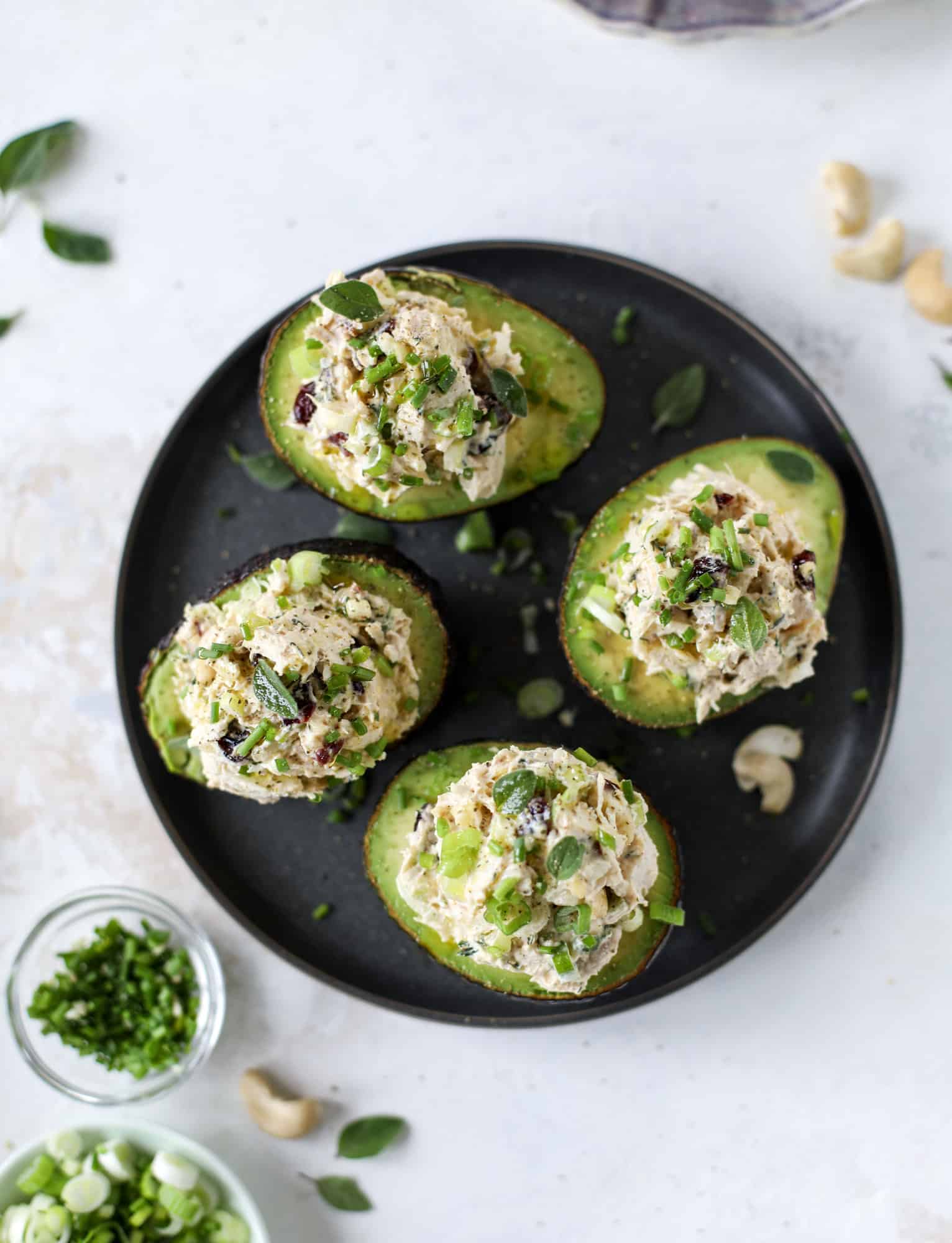 These smoky chicken salad stuffed avocados are lunchtime gold! They are super easy to throw together, satisfying and pretty darn great for you. Made with greek yogurt, some tangy mustard and dried cherries for sweetness, they are delish! I howsweeteats.com #chicken #salad #stuffed #avocados #greekyogurt