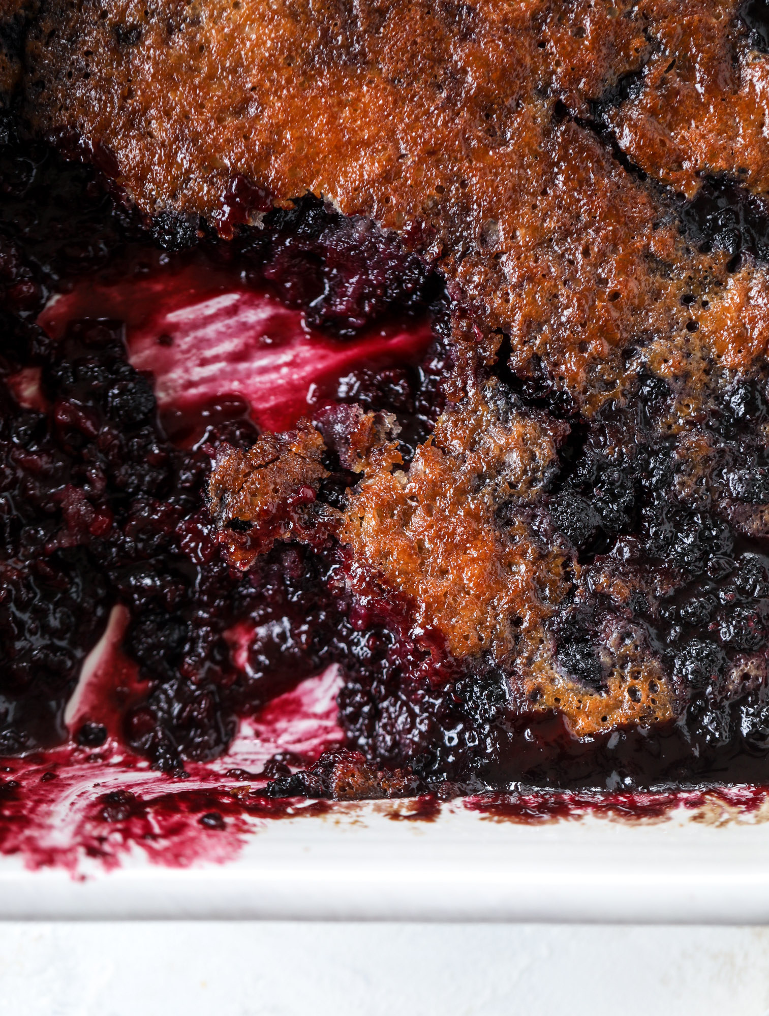 This black raspberry cobbler is a summer dream come true! The bursting black raspberries are rich and sweet, then add in a touch of lavender for incredible flavor and you're all set. The cobbler cake topping is perfect for vanilla ice cream. Win! I howsweeteats.com #black #raspberry #cobbler #lavender #summer #desserts #icecream