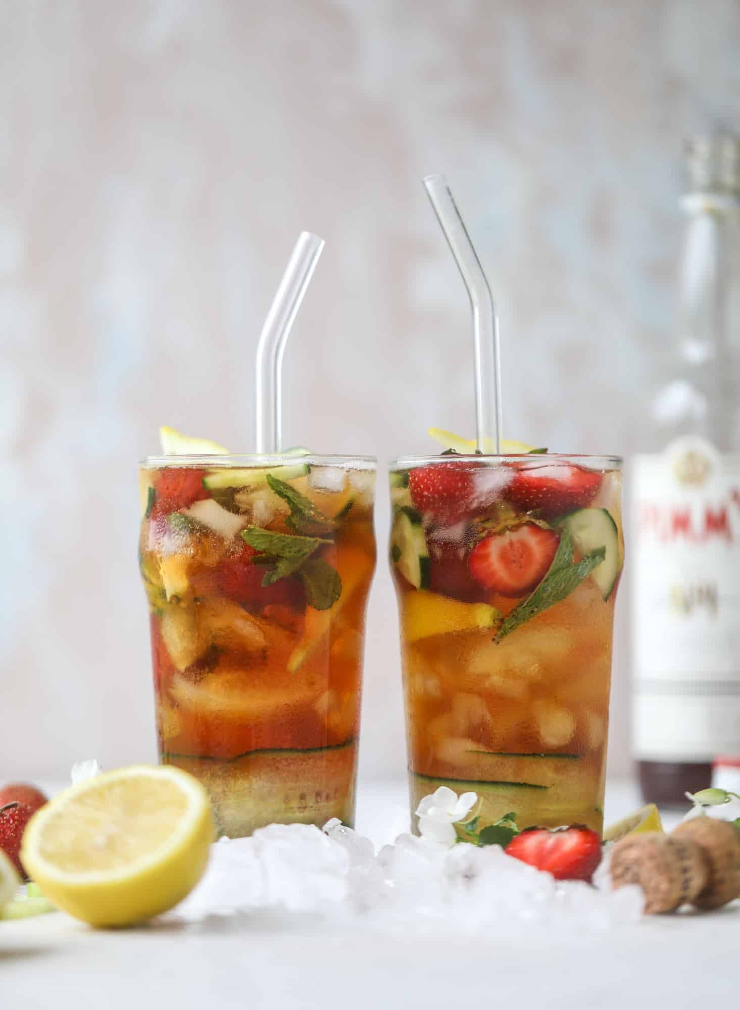 I love a delicious Pimm's Cup in the heart of summer! This was is topped with sparkling rosé wine and filled with strawberries, cucumbers and lemon wedges. It's super refreshing and perfect on hot hot days! I howsweeteats.com #pimms #cup #recipe #cocktails #rosé #sparkling #summer