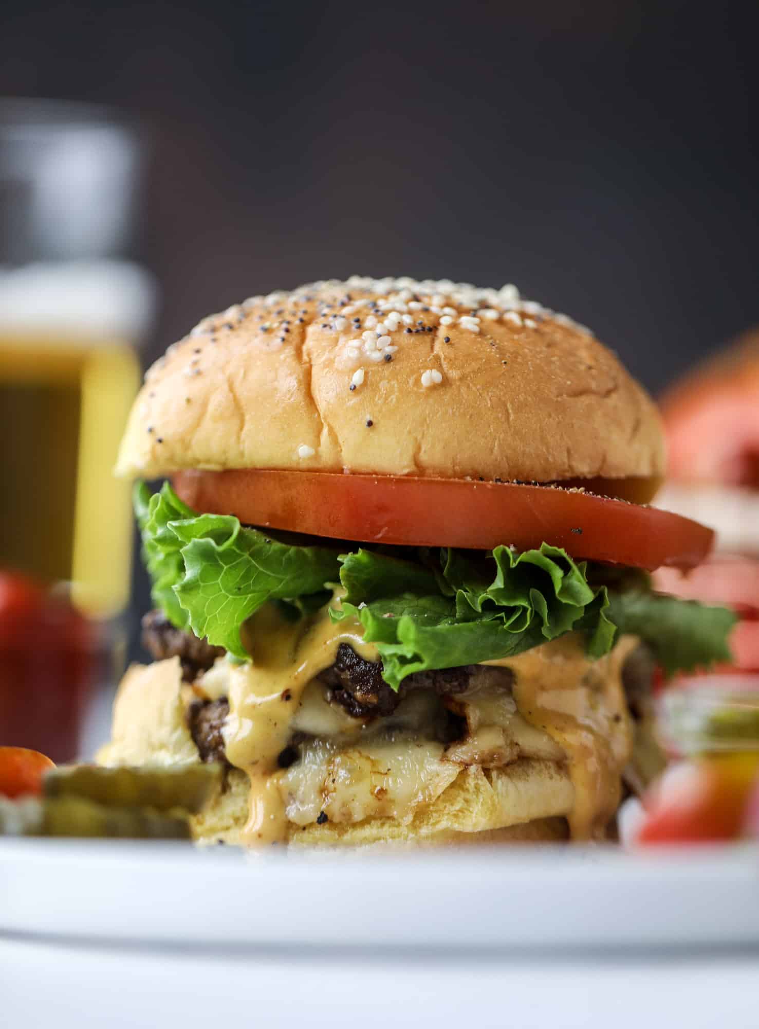 These smash burgers are to die for! All you need are a few ingredients and 30 minutes to make these smash burgers happen. Topped with melty smoked gouda and topped with a creamy, tangy house sauce, these are the best burgers ever! I howsweeteats.com #smash #burgers #smoked #gouda #special #sauce