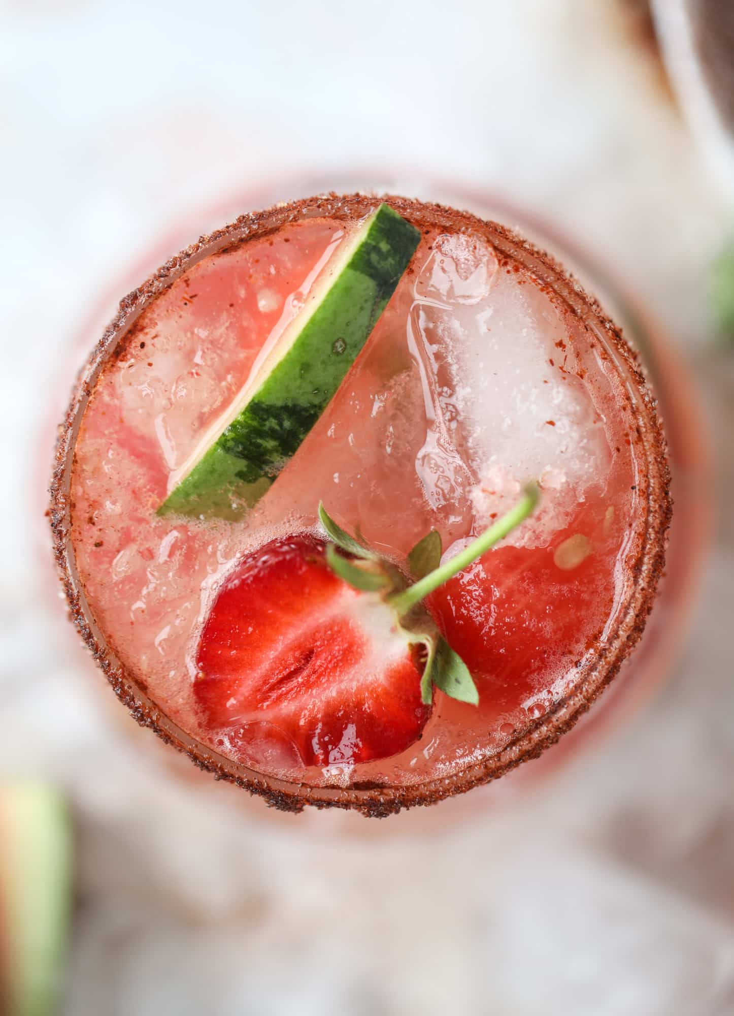 This spicy watermelon sangria is super refreshing, light, delicious and perfect for a hot summer day! Complete with an entire bottle of rosé, watermelon juice, melon balls, strawberries and brandy, this is the best summer cocktail in a pitcher! I howsweeteats.com #spicy #watermelon #sangria #cocktails #rosé