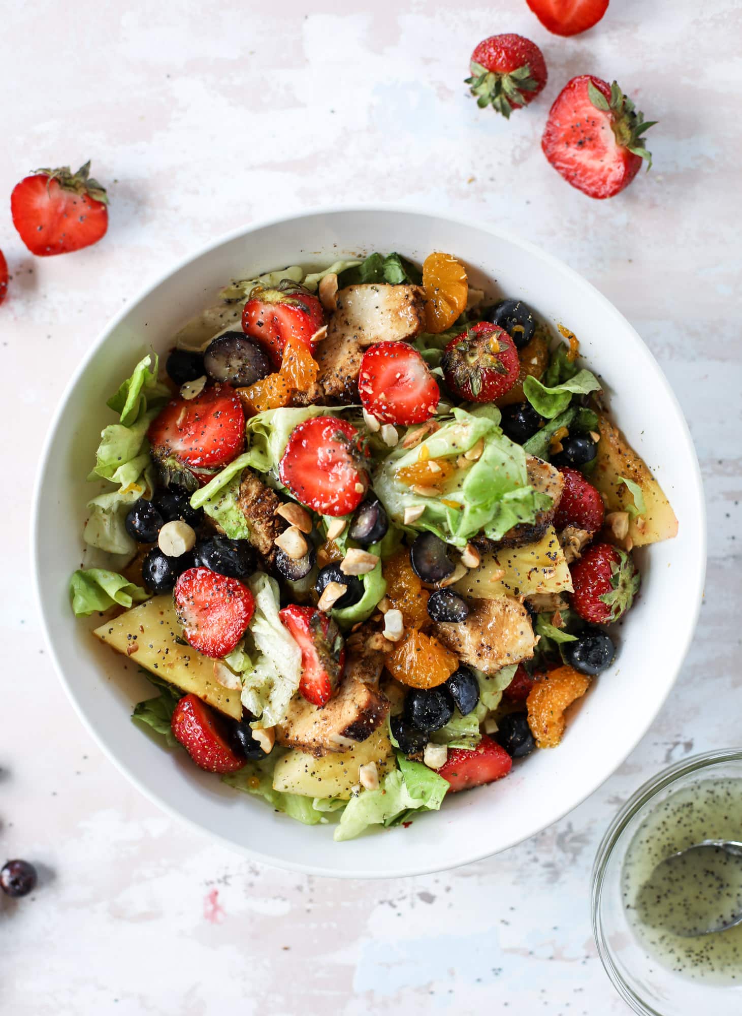 This copycat Panera strawberry poppyseed salad is absolutely delicious and refreshing and perfect for summer! Serve it with grilled chicken like the recipe here or swap for shrimp or fish. I howsweeteats.com #strawberry #poppyseed #salad #chicken #panera #copycat