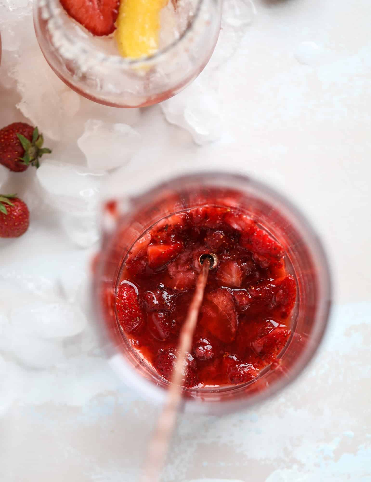This tequila rosé spritz cocktail is perfectly refreshing for hot summer nights. A mix between a margarita and spritzer, this starts with muddled strawberries and honey, a shot of tequila and is topped off with your favorite rosé wine! I howsweeteats.com #tequila #rosé #wine #spritz #cocktail #strawberries