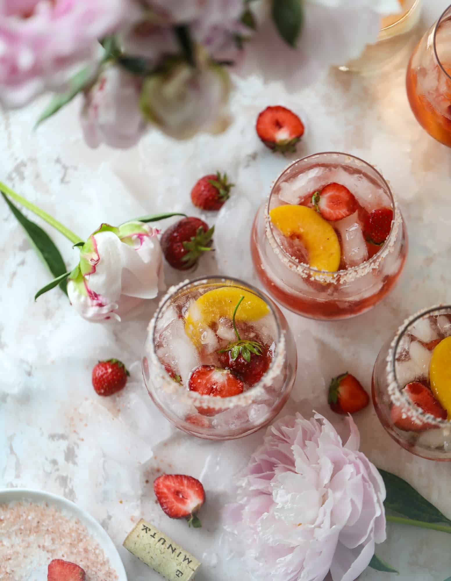 This tequila rosé spritz cocktail is perfectly refreshing for hot summer nights. A mix between a margarita and spritzer, this starts with muddled strawberries and honey, a shot of tequila and is topped off with your favorite rosé wine! I howsweeteats.com #tequila #rosé #wine #spritz #cocktail #strawberries