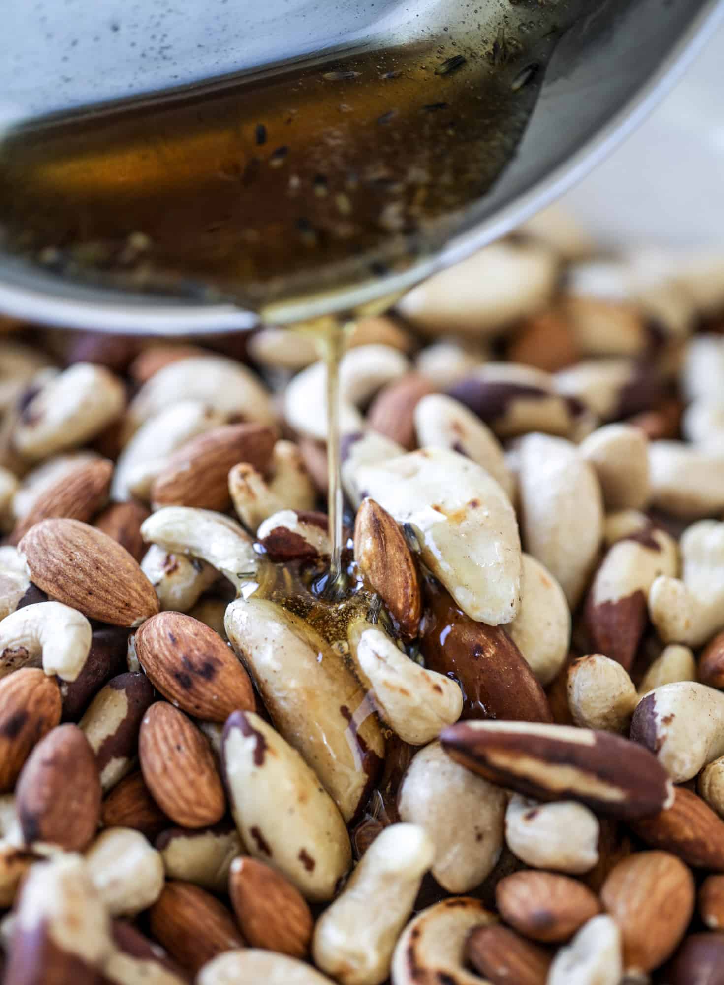 These salted honey lavender nuts are the best snack to make for when you're on the go or when you need a perfect appetizer for your dinner party. Roasted, sweet and salty with a hint of lavender makes these irresistible! I howsweeteats.com #honey #lavender #nuts #salted #almonds #cashews #snacks #appetizers
