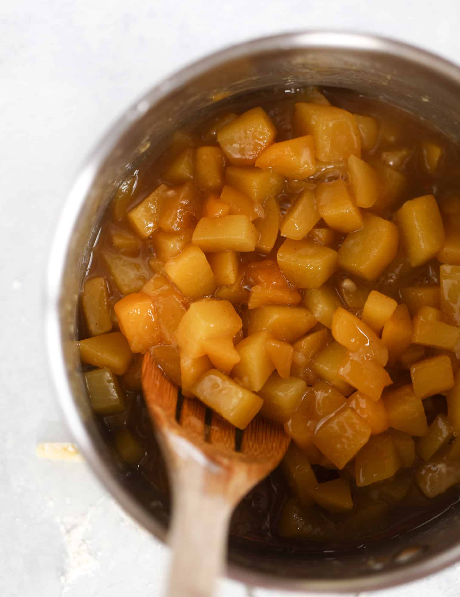 These little peach hand pies are super easy to make and oh-so delicious for summer! A warm and syrupy homemade peach filling made with brown sugar and bourbon, stuck inside a flakey all-butter crust and sprinkled with coarse sugar. SO GOOD. I howsweeteats.com #peach #hand #pies #mini #dessert #summer
