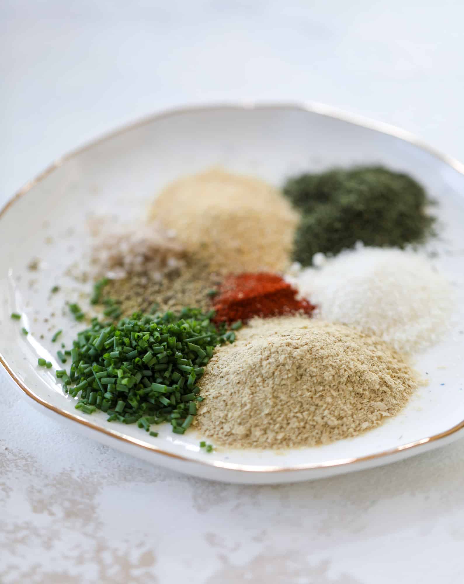 This greek yogurt ranch dip is fabulous for a summertime pool tip and it's full of greens! Made with a homemade ranch spice seasoning, lots of shredded greek kale and greek yogurt, it's the perfect dip for crudite or chips! I howsweeteats.com #kale #greek #yogurt #ranch #dip #healthy #snacks