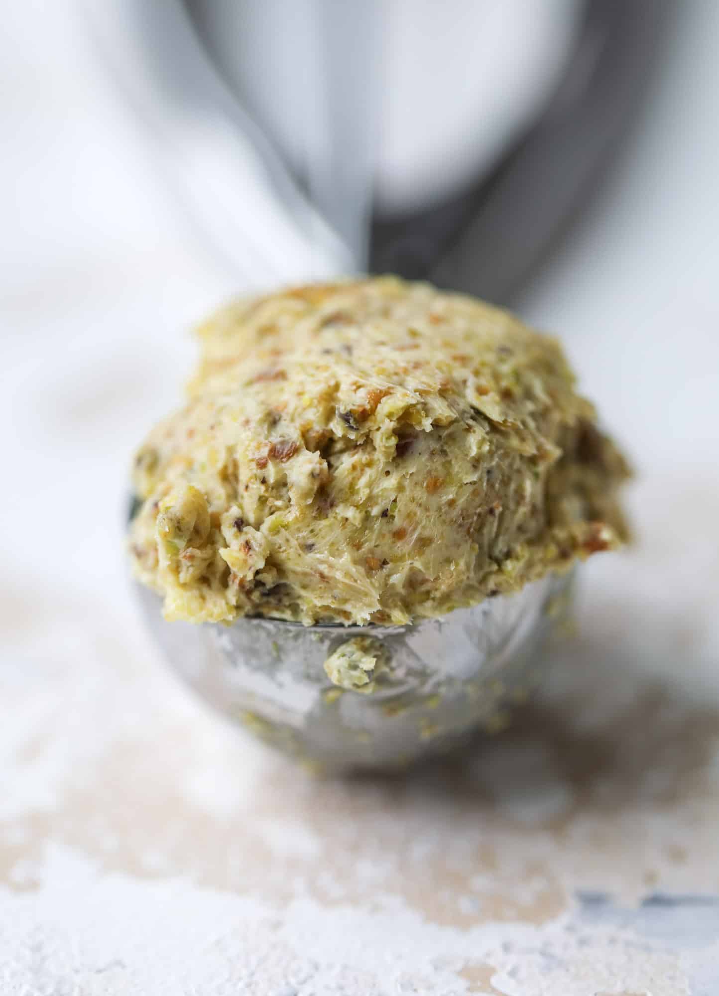 This incredible dutch baby recipe is fluffy and light and perfect for breakfast! It's sprinkled with pistachio sugar and served with pistachio butter and fresh blueberries. It's super easy, simple and always a hit! I howsweeteats.com #dutch #baby #pistachio #blueberry #breakfast