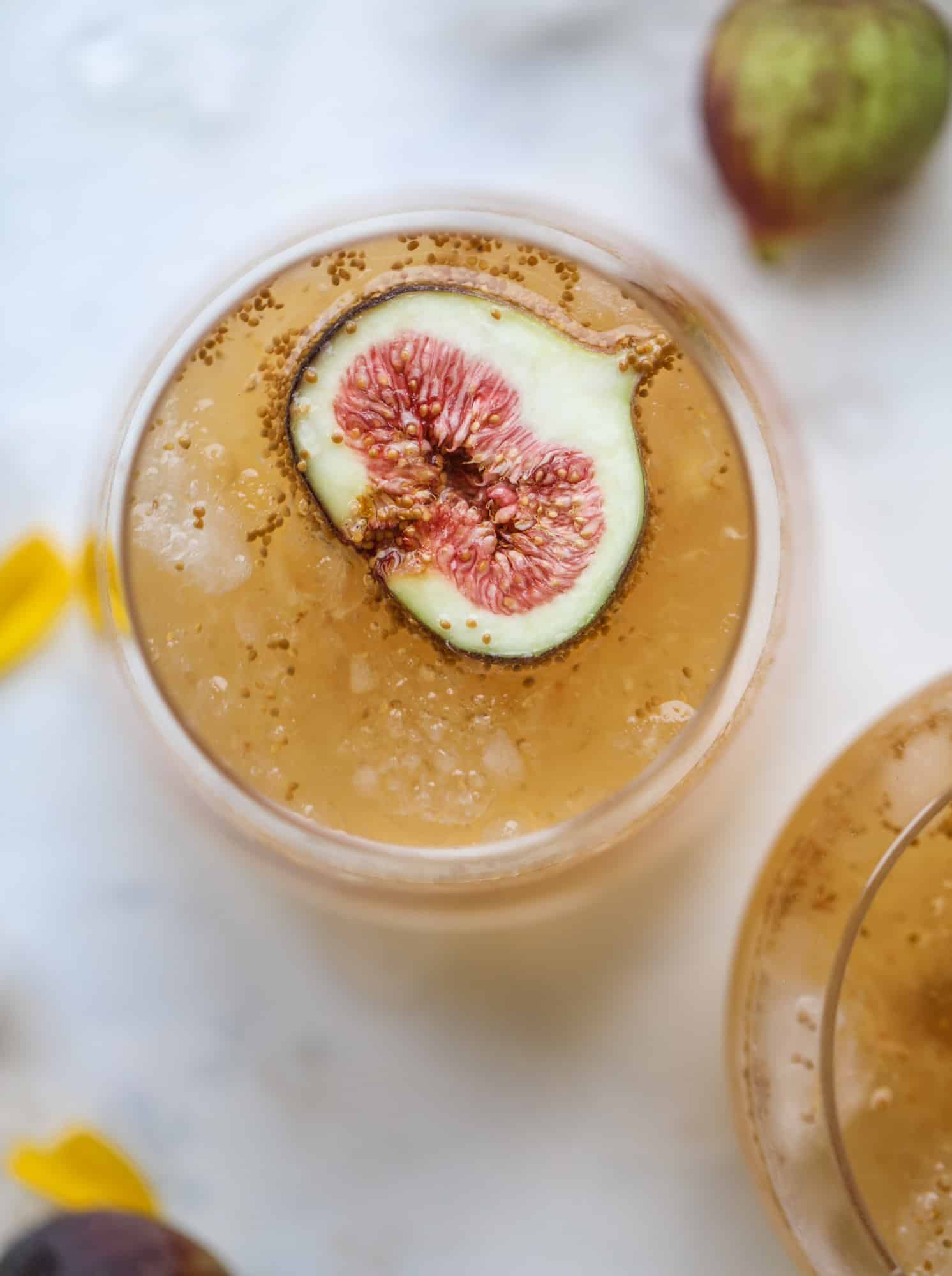 This new fig cocktail is so delicious and perfect for your fresh juicy figs! Muddle the fresh figs with brown sugar and a touch of lemon, then add them to a glass with crushed ice and pour some bubbly on top. I love Prosecco, but you can use a sweeter bubbly too! I howsweeteats.com #fig #cocktail #brown #sugar #prosecco
