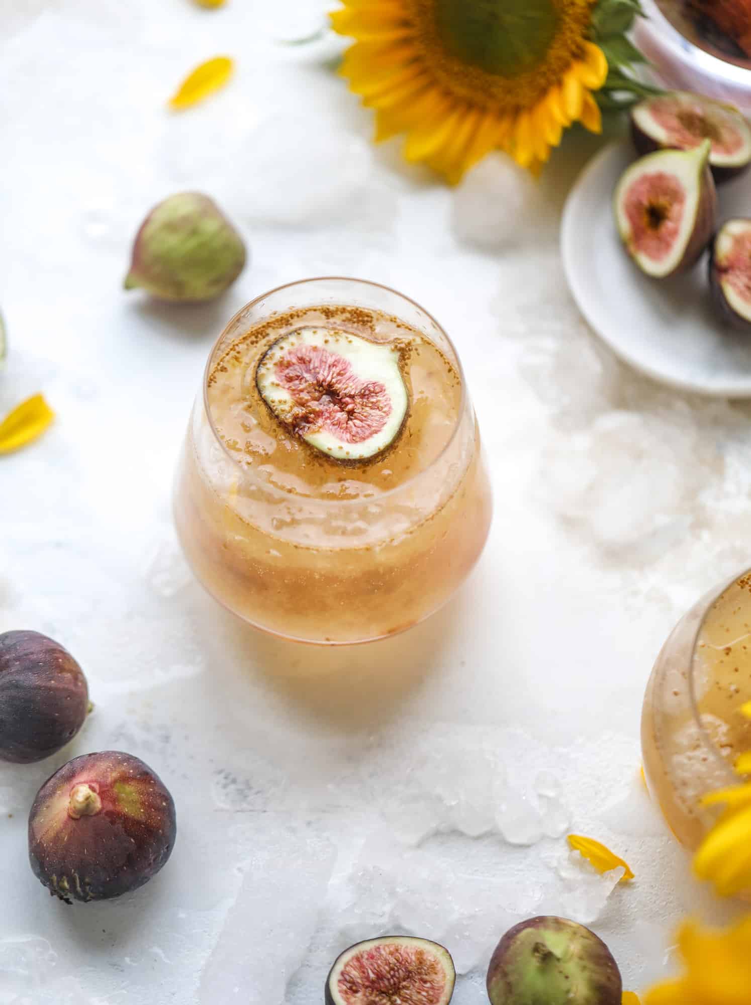 This new fig cocktail is so delicious and perfect for your fresh juicy figs! Muddle the fresh figs with brown sugar and a touch of lemon, then add them to a glass with crushed ice and pour some bubbly on top. I love Prosecco, but you can use a sweeter bubbly too! I howsweeteats.com #fig #cocktail #brown #sugar #prosecco