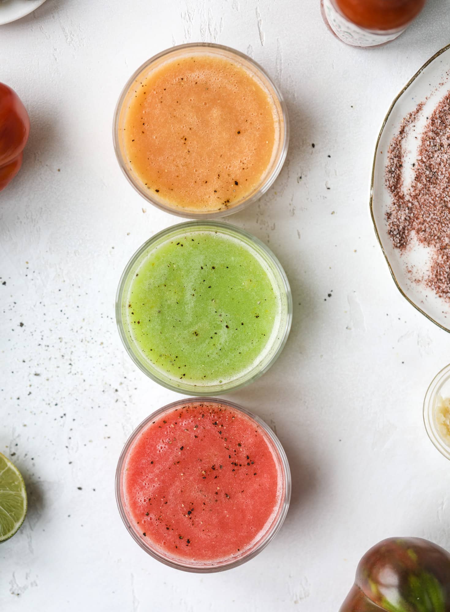 This bloody mary recipe is made with fresh heirloom tomatoes - the gems of summer! The colors swirl together to create a stunning drinking that is loaded with smoky, spicy flavor. Top with your favorite snacks foe the perfect brunch! I howsweeteats.com #bloody #mary #recipe #best #heirloom #tomatoes #cocktail