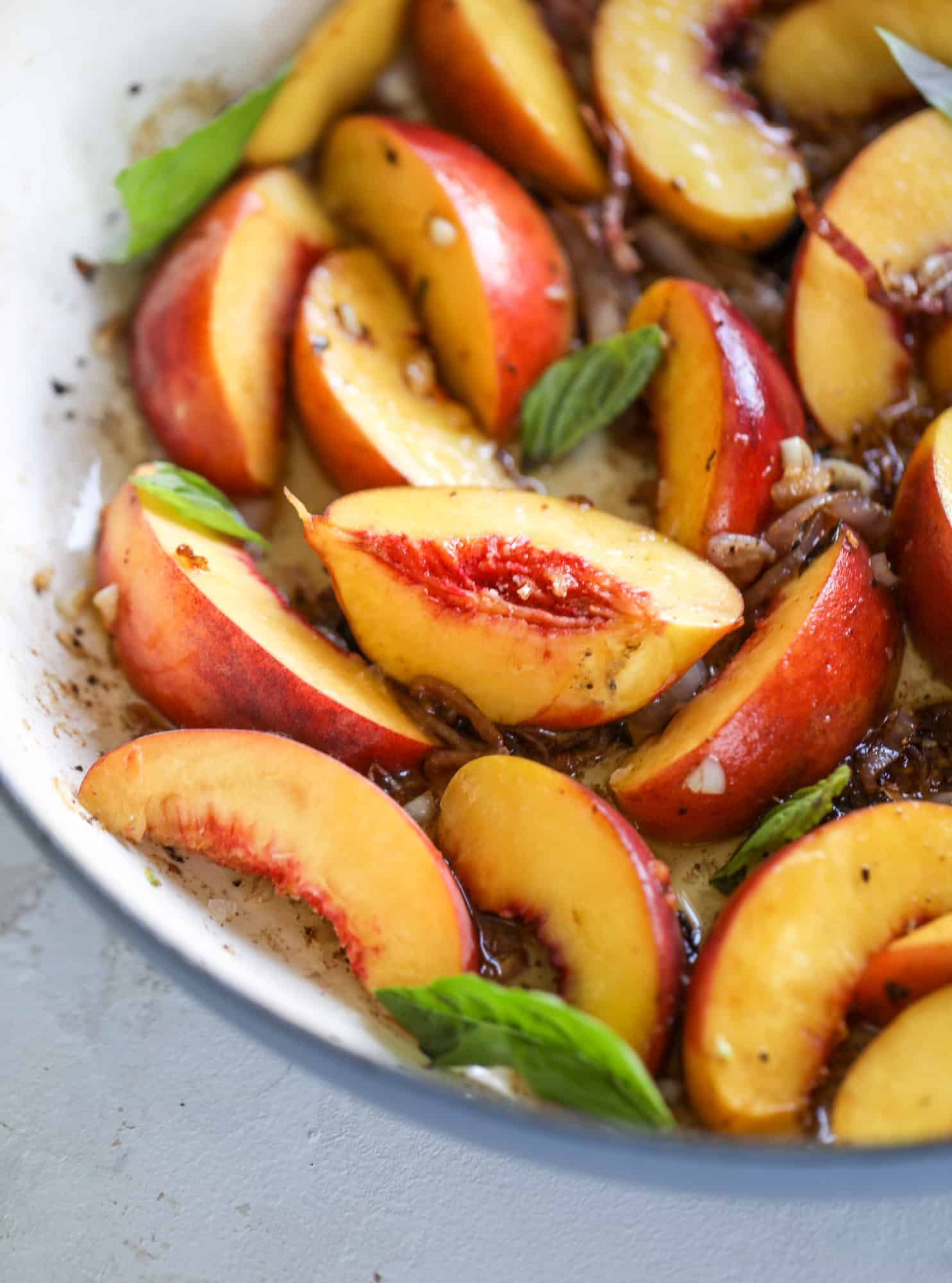 This amazing summertime one pot chicken is made with fresh peaches and basil and takes no time at all. The sweet and savory combination is perfect for a quick weeknight meal; the sauce is amazing for dipping and the chicken is flavorful as can be. I howsweeteats.com #chicken #peach #basil #easy #dinner #recipe #summer #healthy
