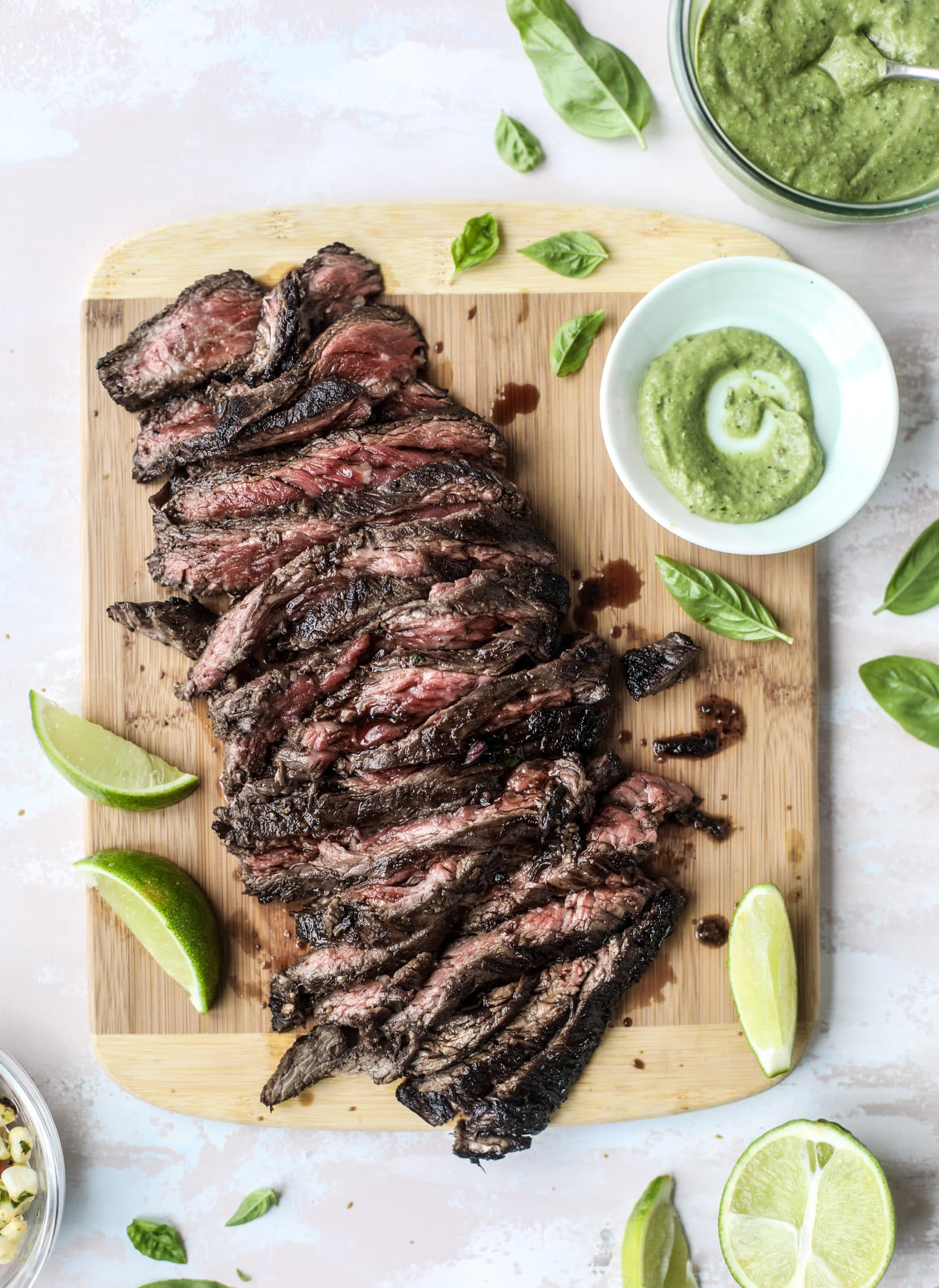 This skirt steak recipe is so super easy and delicious! Marinate it for a bit, prepare it to your liking then serve it with the most flavorful avocado pesto and grilled corn relish. Feels like a fancy restaurant meal and will make you love skirt steak forever! I howsweeteats.com #skirt #steak #avocado #pesto #corn #relish #recipes
