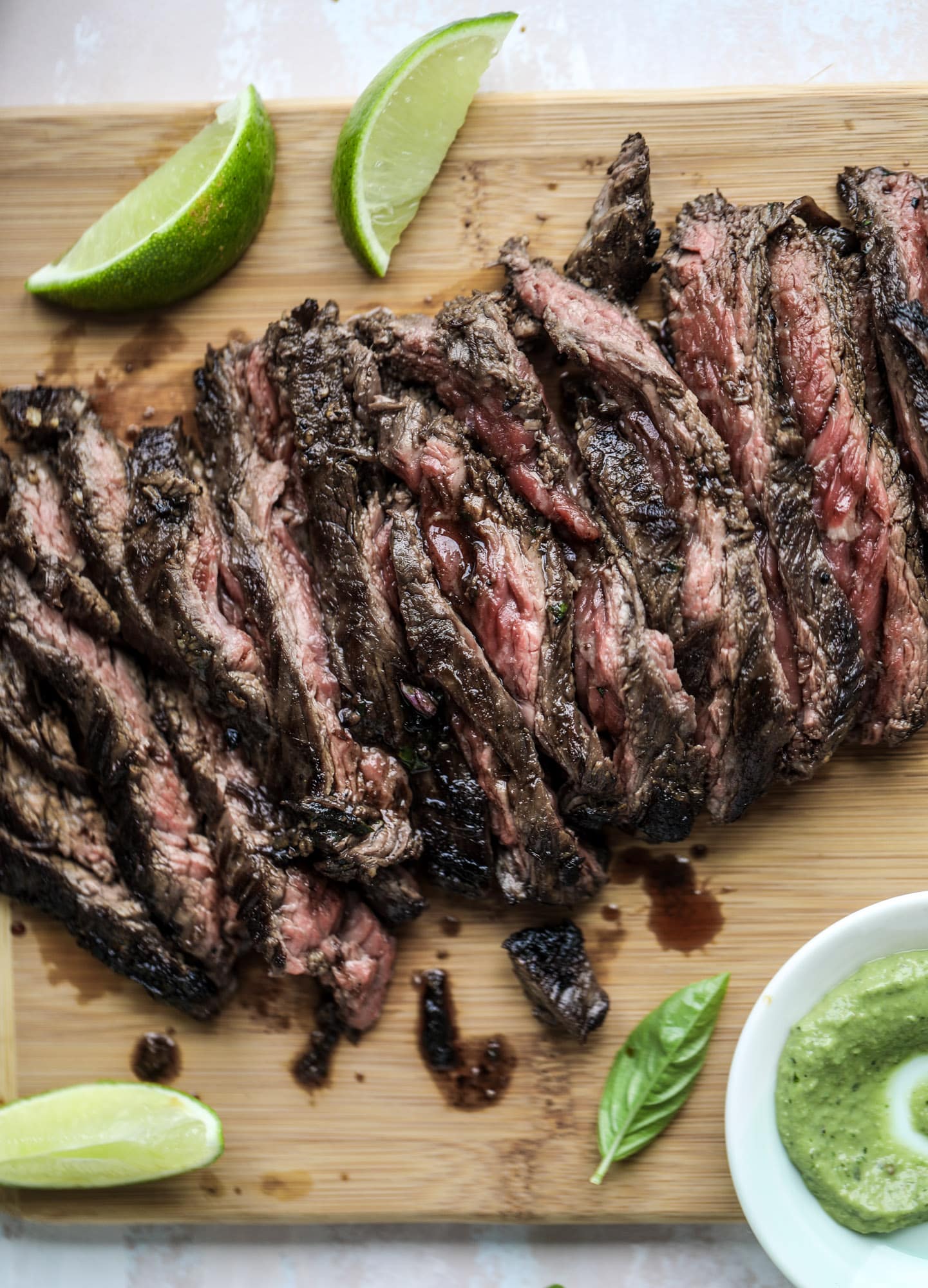 This skirt steak recipe is so super easy and delicious! Marinate it for a bit, prepare it to your liking then serve it with the most flavorful avocado pesto and grilled corn relish. Feels like a fancy restaurant meal and will make you love skirt steak forever! I howsweeteats.com #skirt #steak #avocado #pesto #corn #relish #recipes