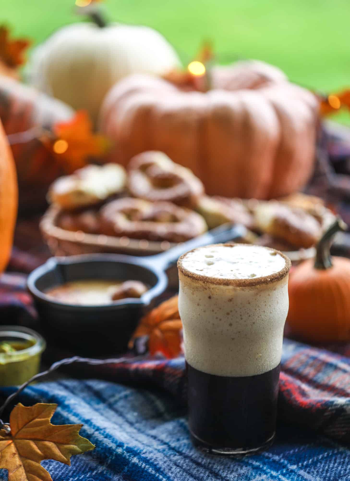This is the cutest way ever to serve the best pumpkin beer! If you do a pumpkin beer party of a pumpkin beer tasting, this pumpkin cooler is an adorable (and easy!) way to make things festive. Kick it up with a hot pretzel bar and lots of dipping sauce too! I howsweeteats.com #pumpkin #beer #cooler #softpretzel #fall #cheese