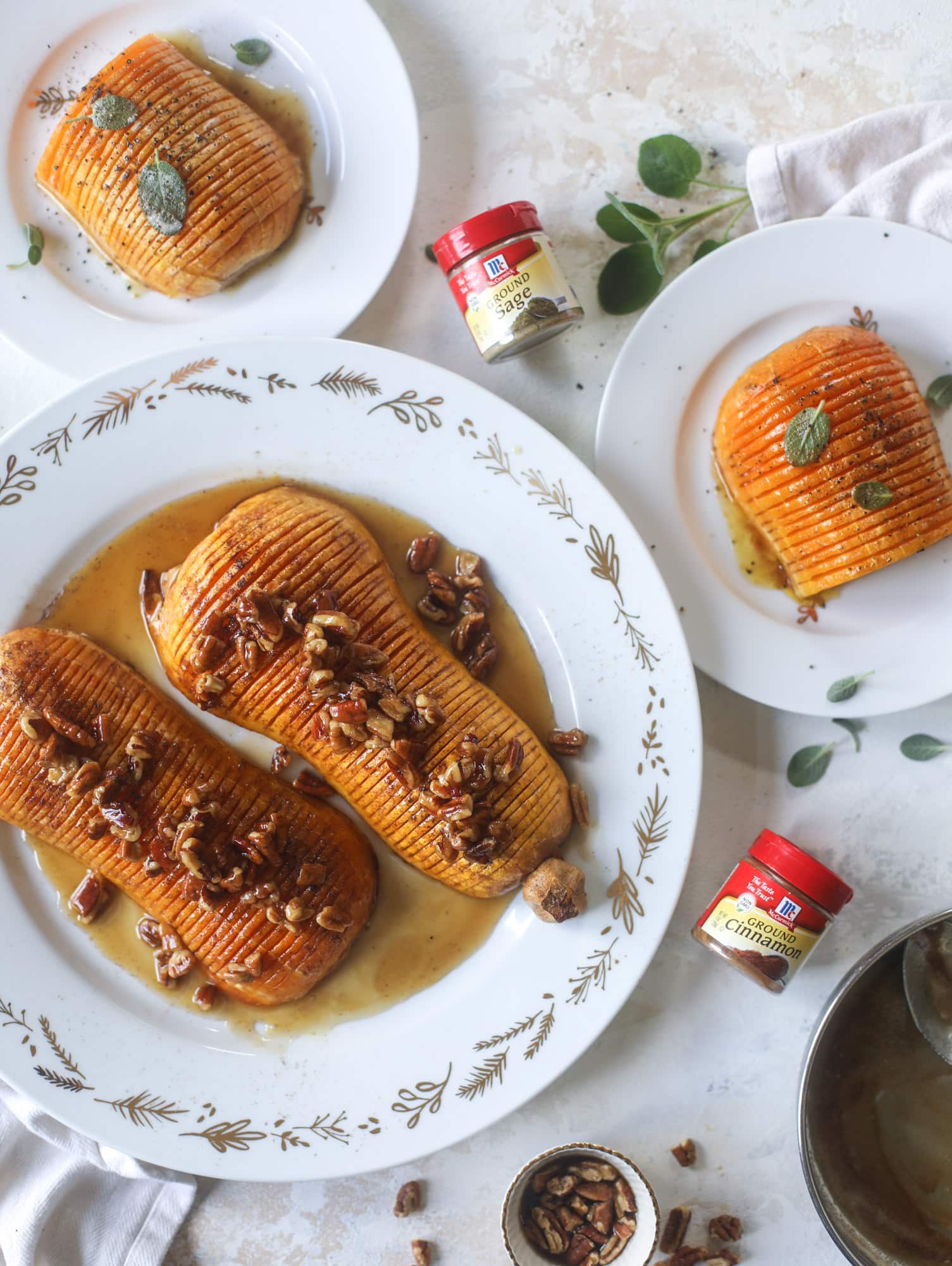 This hasselback butternut squash is perfect for Thanksgiving - and you can easily make it two ways! We have a maple pecan hassleback butternut squash and a brown butter sage hasselback butternut squash. Delicious! I howsweeteats.com #hasselback #butternutsquash