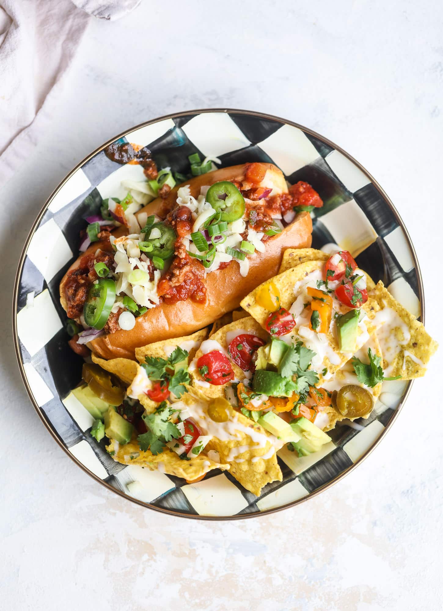 This is the best way to set up a chili bar! All my tips and tricks for setting up a perfect chili bar with multiple toppings, a nacho bar, hot dogs - all done with prep to make the day of the party super easy! This chili bar is goals. I howsweeteats.com #chili #bar #how #to