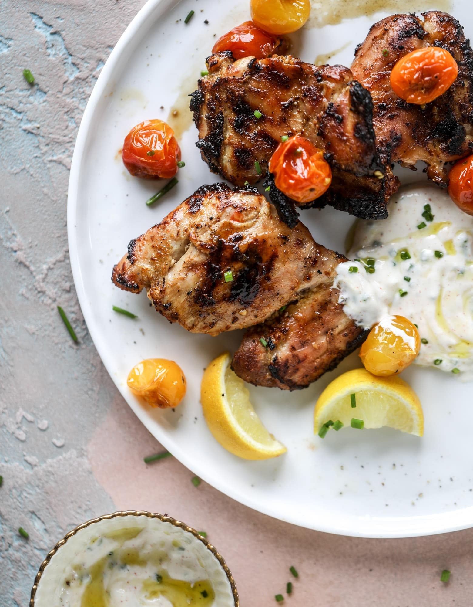 This yogurt marinated chicken recipe is super flavorful, tender, juicy and delicious. The fresh lemon adds a kick of flavor and it's a versatile recipe you can make for lunch or dinner. Grill it and serve with your favorite side, then use the leftovers for lunch! I howsweeteats.com #yogurt #chicken #lemon #grilled #healthy #recipes