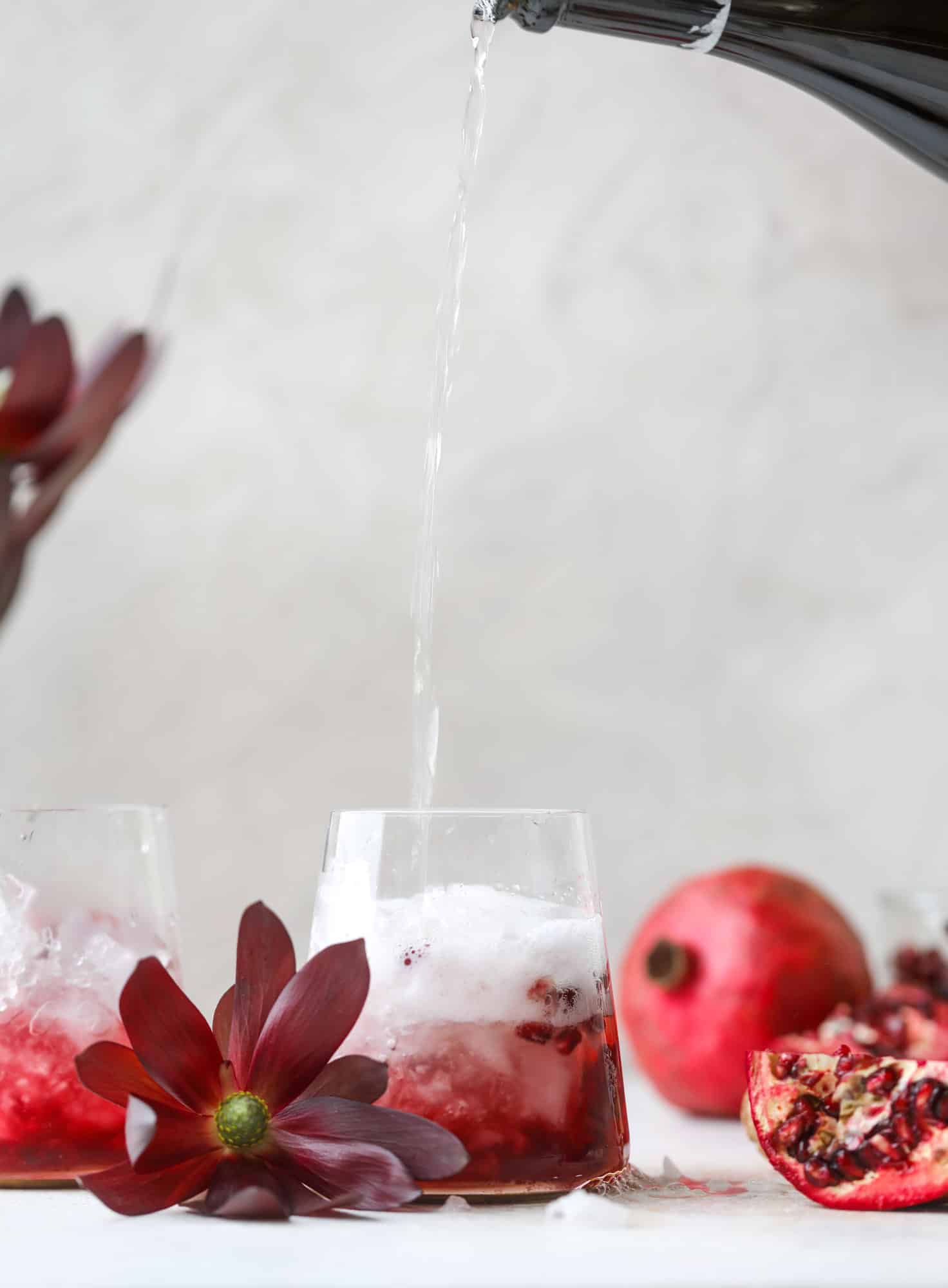 The pomegranate smash cocktail is a great drink for fall, Thanksgiving and the holiday season. Pomegranate juice, vodka and prosecco create a bubbly delicious drink that is garnished with pomegranate arils and rosemary. So festive! I howsweeteats.com #pomegranate #smash