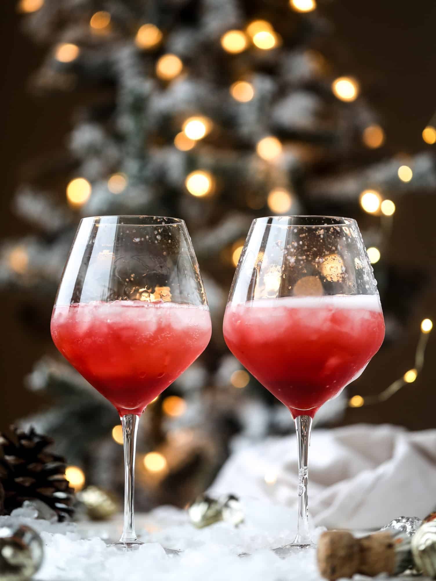 This winter aperol spritz cocktail is a seasonal spin on the classic aperol spritz! Festive cranberry and classic orange come together with prosecco and club soda to create a super light and refreshing cocktail for the holidays! I howsweeteats.com #aperol #spritz