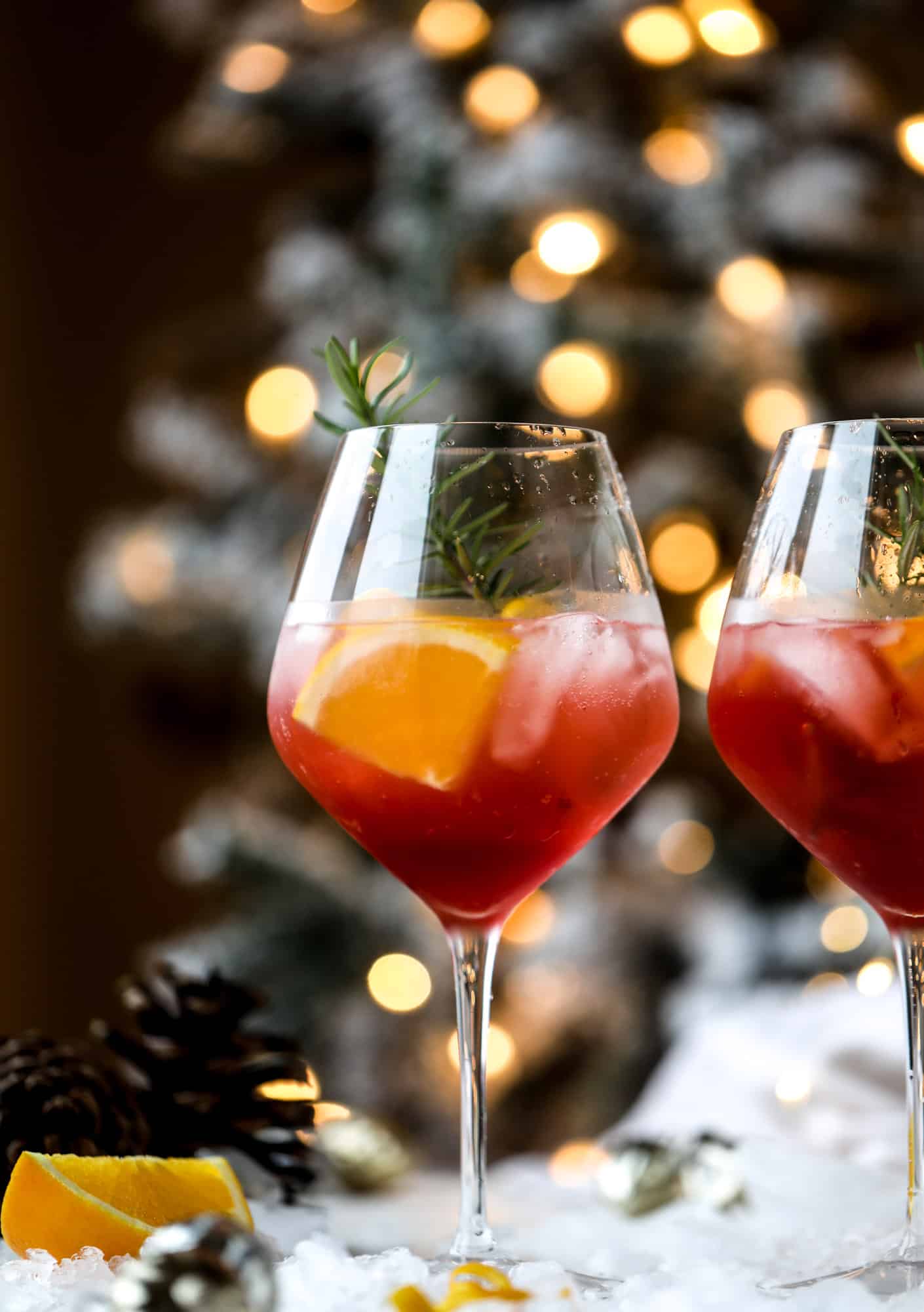 This winter aperol spritz cocktail is a seasonal spin on the classic aperol spritz! Festive cranberry and classic orange come together with prosecco and club soda to create a super light and refreshing cocktail for the holidays! I howsweeteats.com #aperol #spritz
