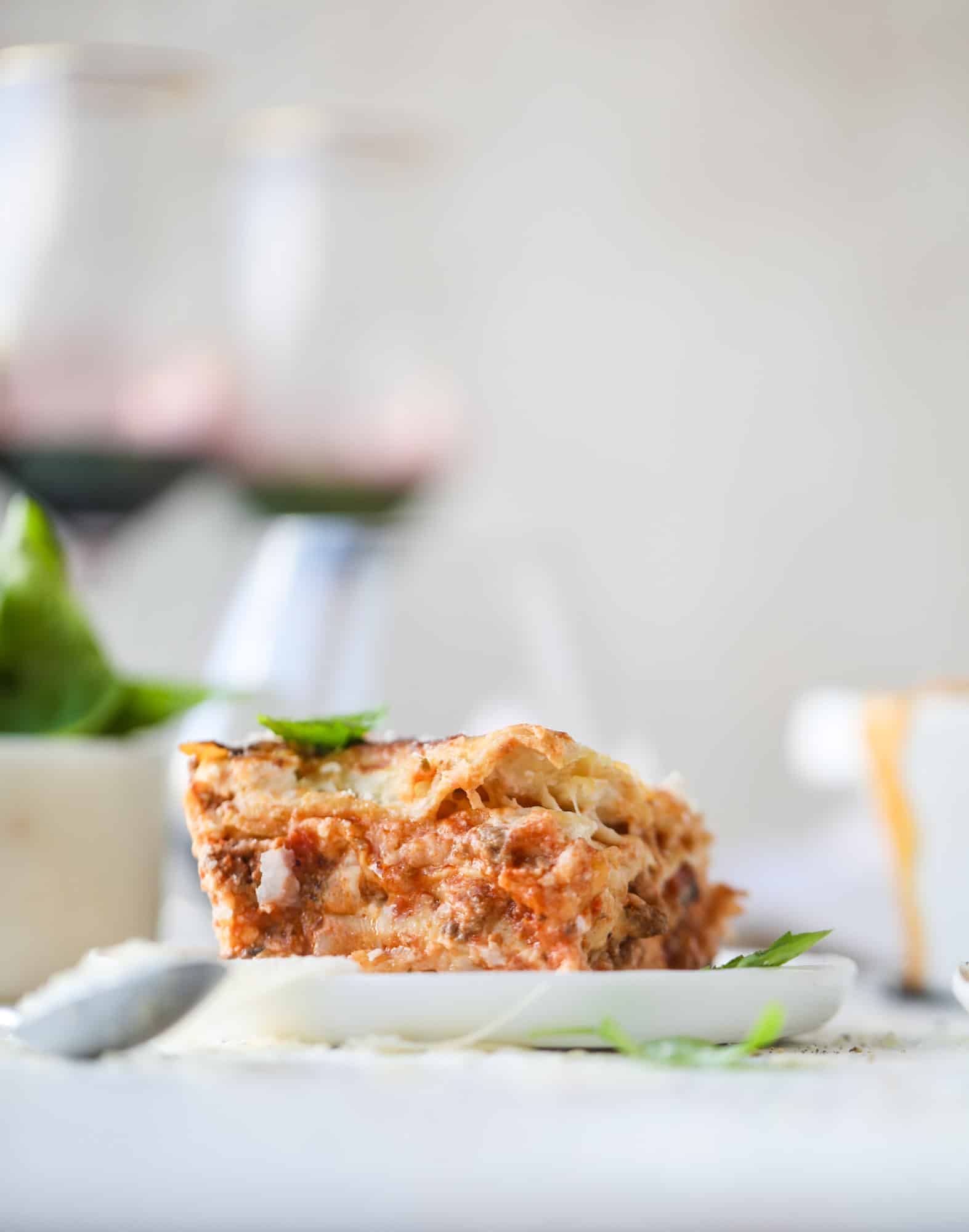 This lasagna bolognese is the ultimate comfort food. Meaty sauce, whole wheat lasagna noodles, creamy bechamel and grated cheese come together to create the most perfect slice of lasagna heaven! I howsweeteats.com #lasagna #bolognese
