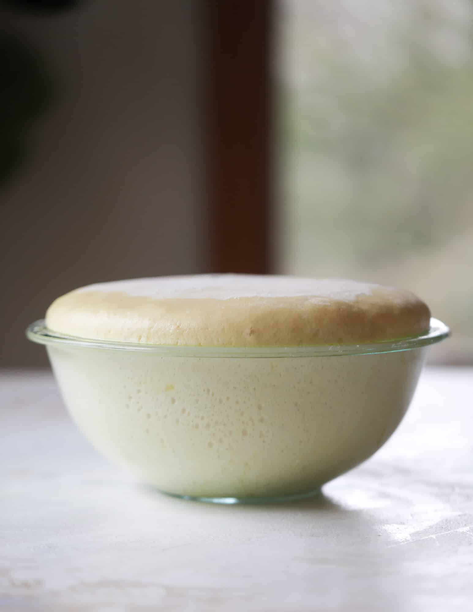 Garlic herb parker house rolls are full of incredibly buttery flavor! They are brushed with a garlic herb butter and are super fluffy, soft and tender. Perfect for Thanksgiving or the holidays and you can make the dough a bit ahead of time! I howsweeteats.com #parkerhouse #rolls