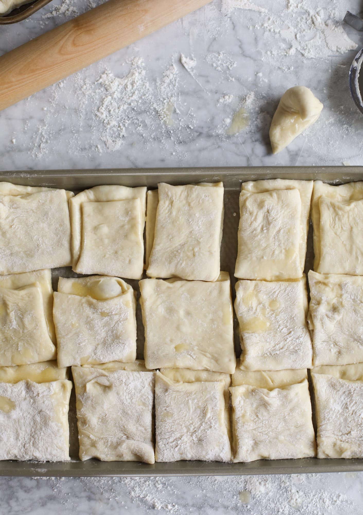 Garlic herb parker house rolls are full of incredibly buttery flavor! They are brushed with a garlic herb butter and are super fluffy, soft and tender. Perfect for Thanksgiving or the holidays and you can make the dough a bit ahead of time! I howsweeteats.com #parkerhouse #rolls