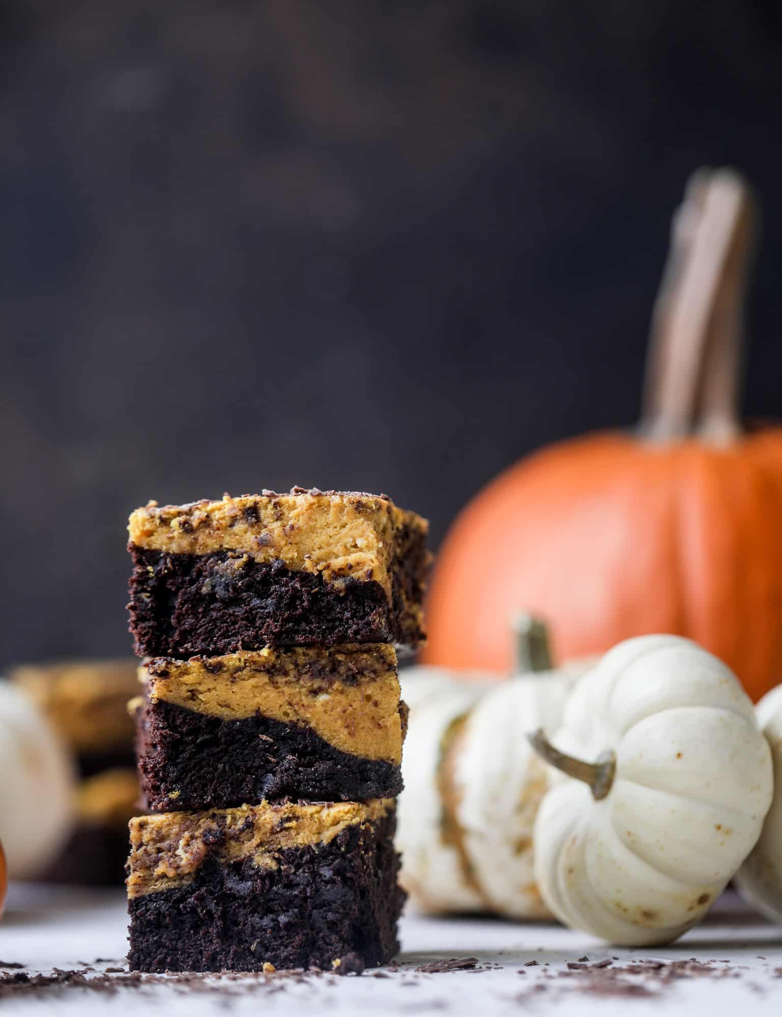 These pumpkin brownies have a fudgy layer of chocolate on the bottom and a silky layer of pumpkin on top! They are so delicious and rich and perfect for fall. The pumpkin brownies come together easily and can be made ahead of time too! I howsweeteats.com #pumpkin #brownies