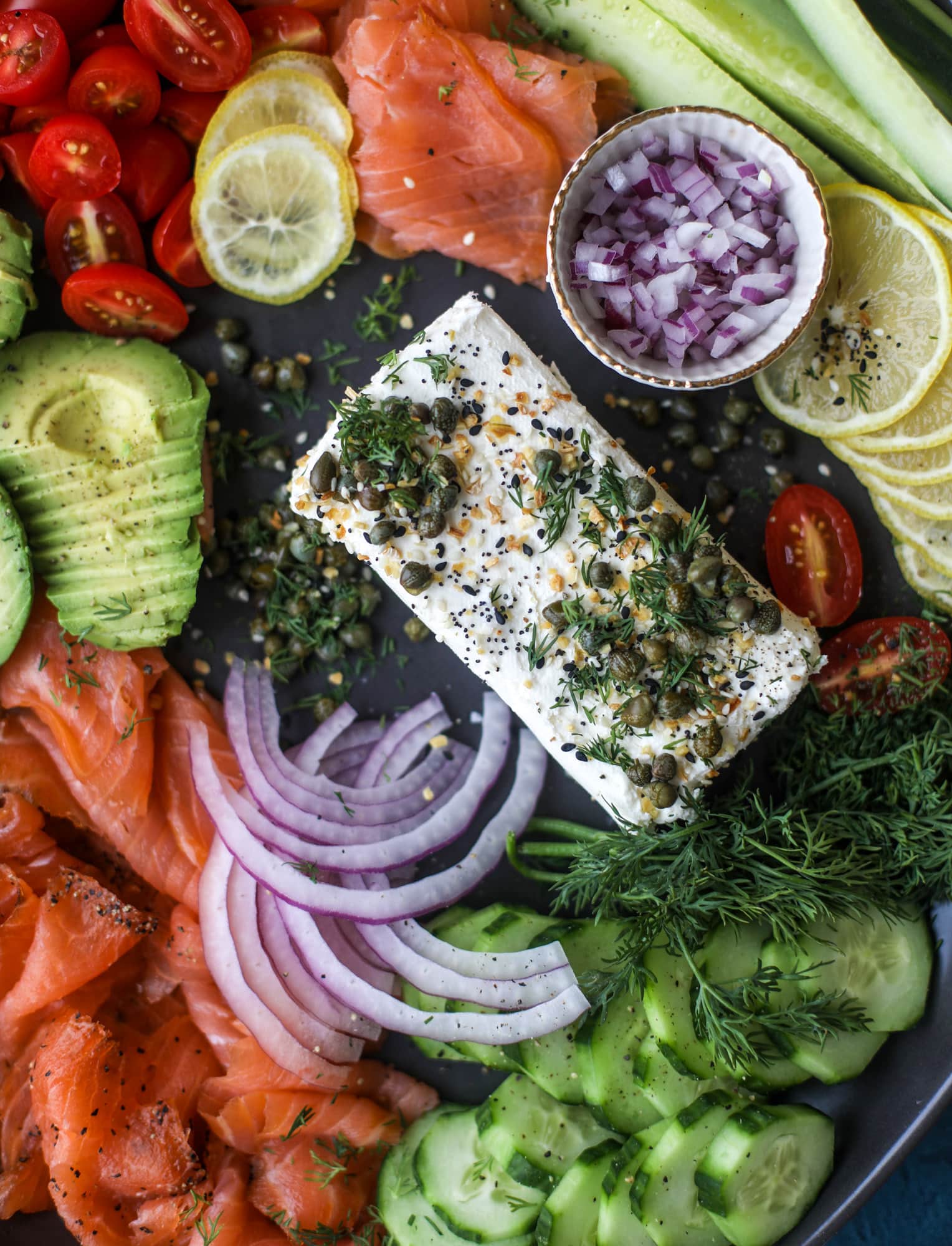This is my favorite way to make an incredible smoked salmon platter! Fresh smoked salmon with bagels, soft boiled eggs, cream cheese and capers, everything seasoning and so much more. Perfect for holiday breakfasts and brunches! I howsweeteats.com #smokedsalmon #platter