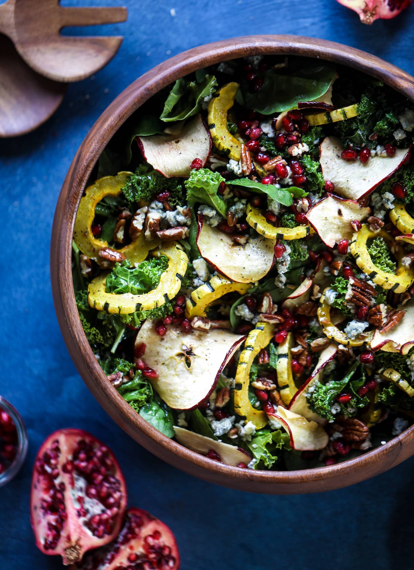 This thanksgiving salad is full of so much autumn flavor. It has toasted pomegranate, delicata squash, toasted pecans, creamy blue cheese and crunchy apple chips. It's light enough to serve before the big meal! I howsweeteats.com #thanksgiving #salad