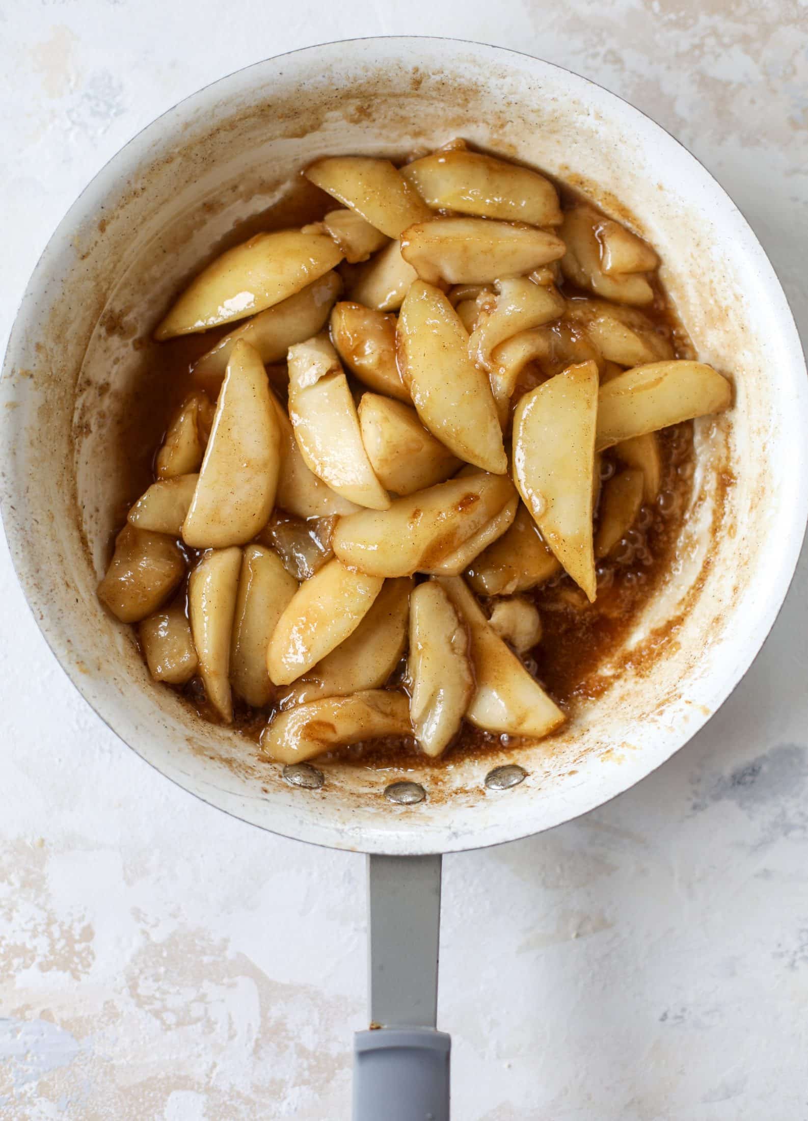 This pear mug pie is the coziest way to enjoy warm, caramelized pears. Topped with vanilla ice cream and the cutest, quick puff pastry stars, these are a great dessert for a dinner party or an easy one to make for yourself on a Saturday night! I howsweeteats.com #pear #mugpie