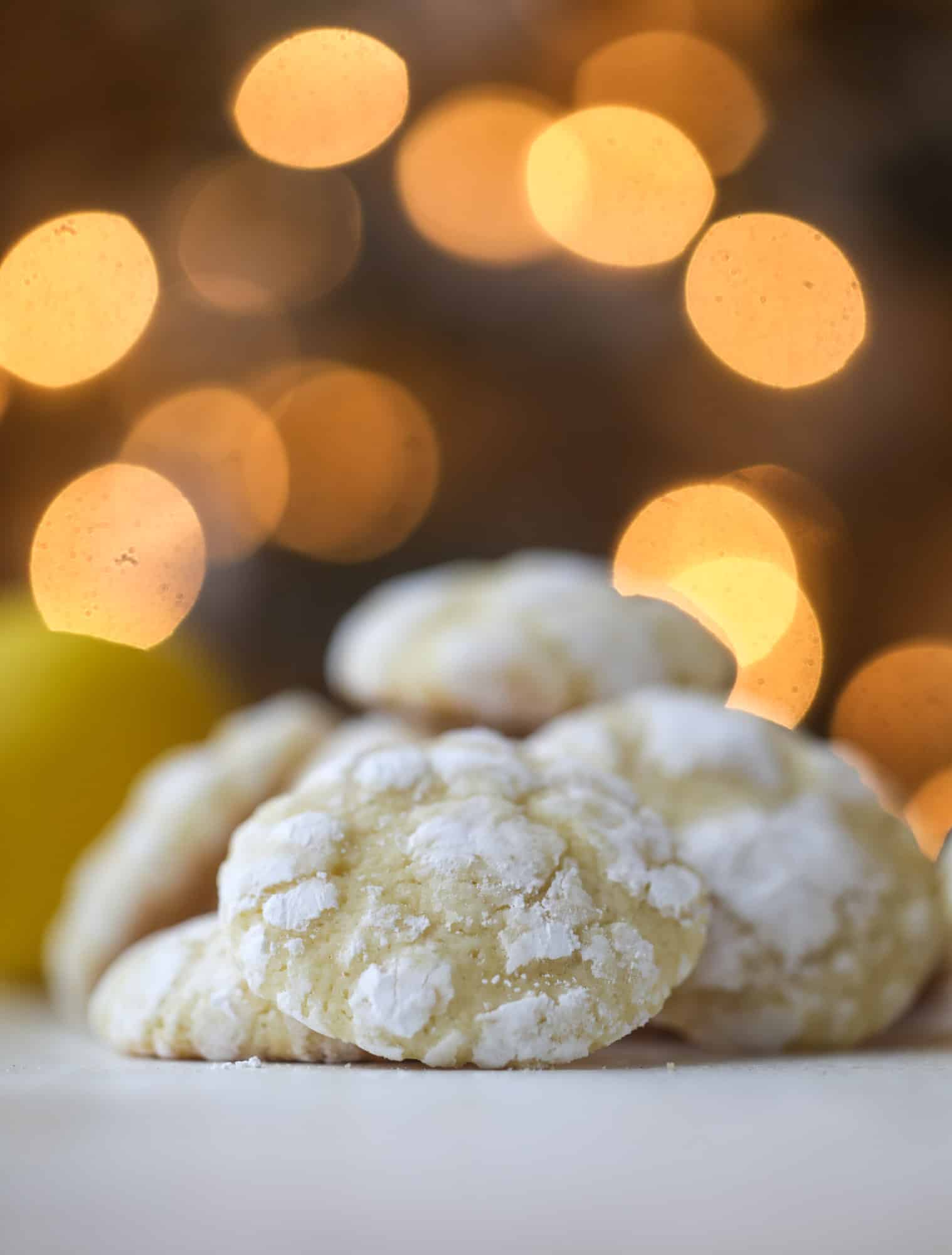 These lemon crinkle cookies are perfect if you love lemon desserts! They take after chocolate crinkle cookies, but are a delightful refreshing lemon flavor sprinkle with powdered sugar. These are always a huge hit! I howsweeteats.com #lemoncrinkle #cookies