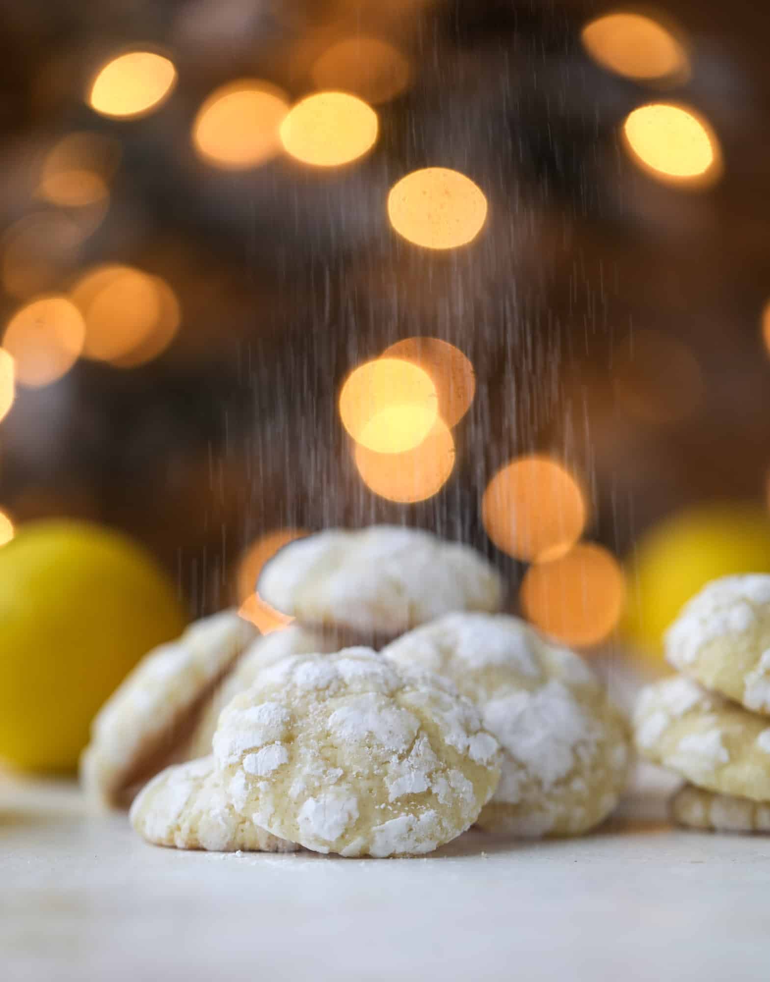 These lemon crinkle cookies are perfect if you love lemon desserts! They take after chocolate crinkle cookies, but are a delightful refreshing lemon flavor sprinkle with powdered sugar. These are always a huge hit! I howsweeteats.com #lemoncrinkle #cookies
