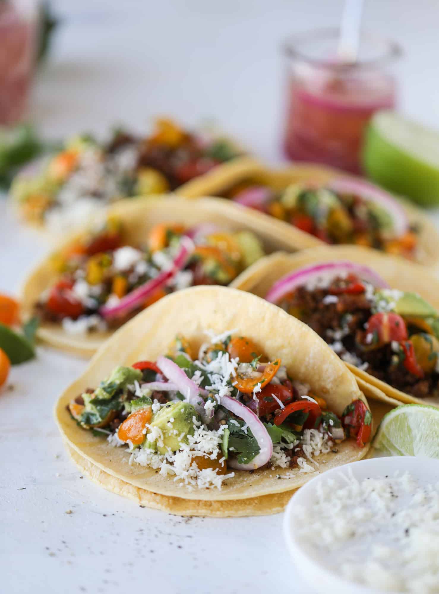 Weeknight ground beef tacos that are anything like the 90s! These are made with a homemade taco seasoning and served with the perfect toppings! I howsweeteats.com #groundbeef #tacos