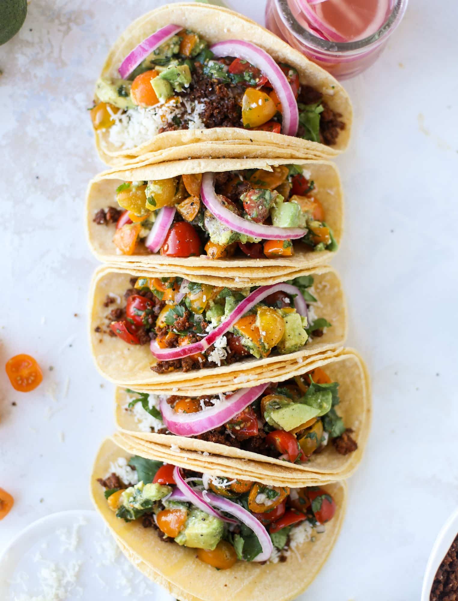Weeknight ground beef tacos that are anything like the 90s! These are made with a homemade taco seasoning and served with the perfect toppings! I howsweeteats.com #groundbeef #tacos
