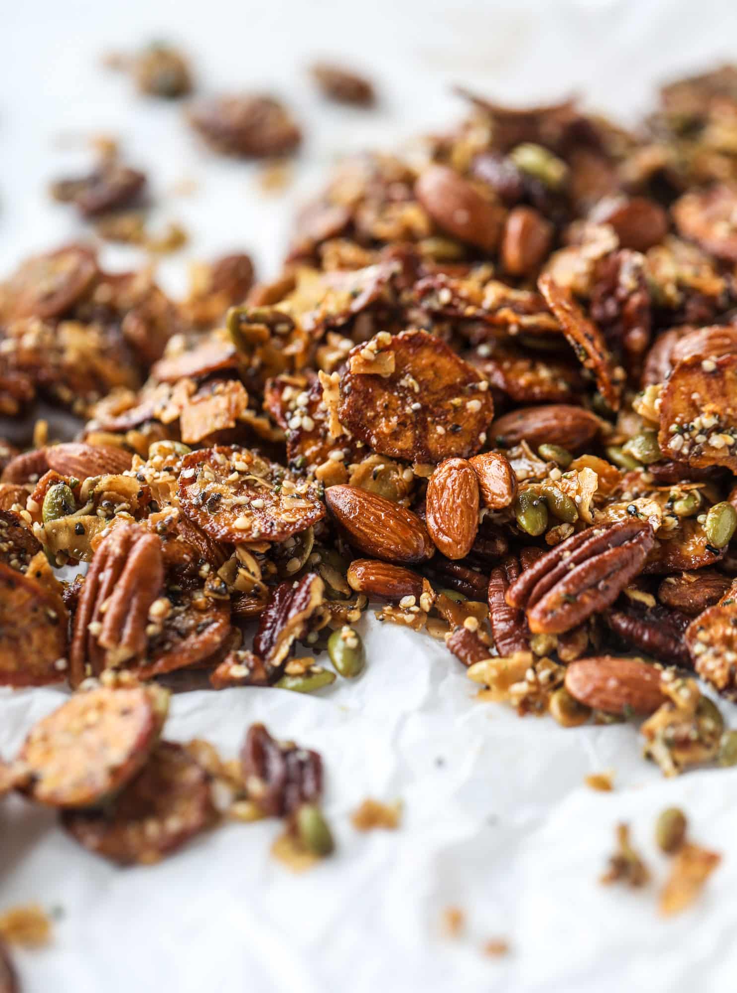 This delicious healthy snack mix is perfect to prep for snacks on the go! It's satisfying, flavorful, both sweet and savory and the best part - is super crunchy. It's full of nuts, some fruit, a bit of coconut, spices, hemp hearts and chia! I howsweeteats.com #healthy #trailmix