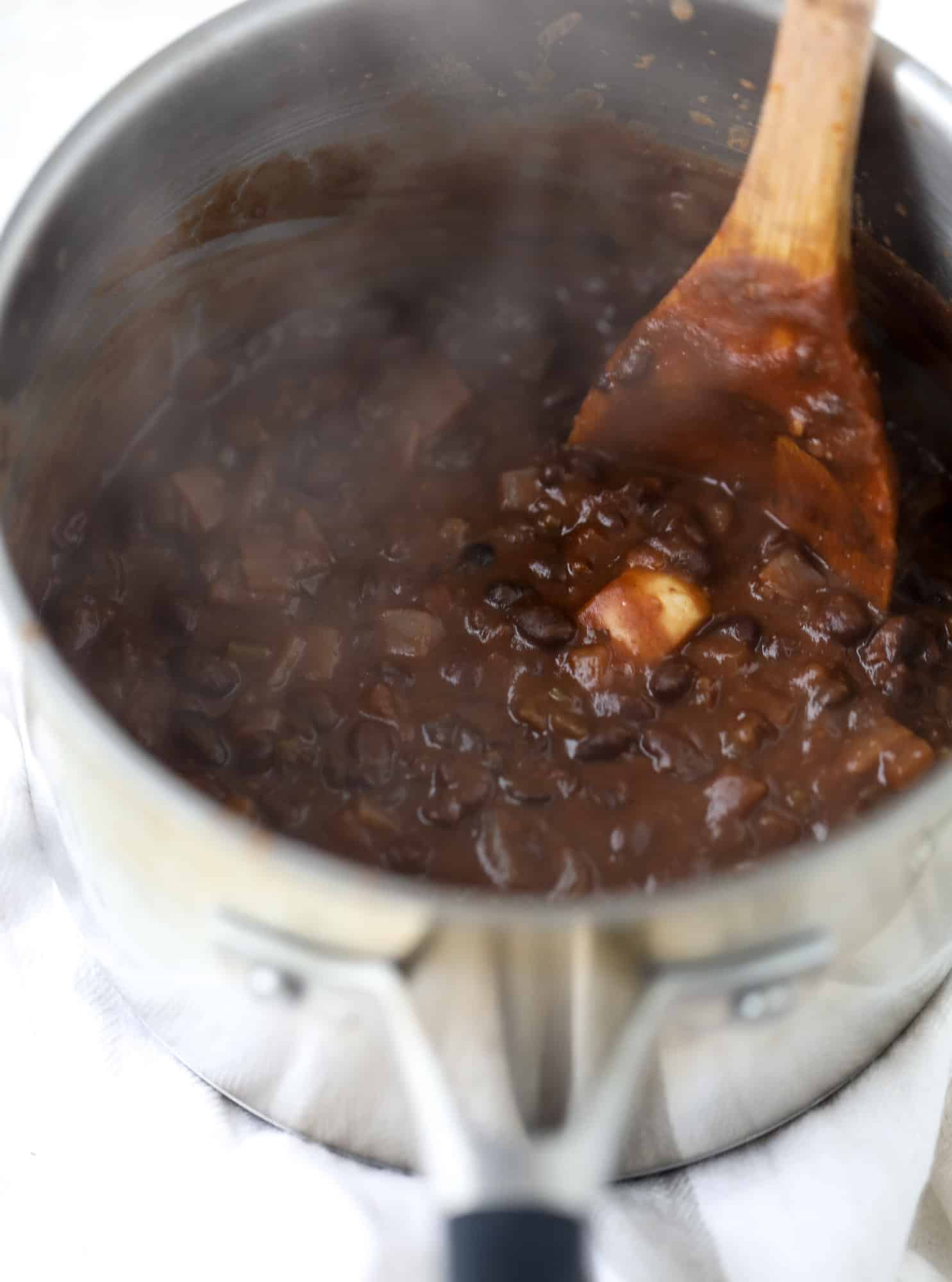 Saucy baked black bean taquitos have a crunchy outside and a creamy, flavorful inside. Served with a pico de gallo, they are an easy weeknight meal! I howsweeteats.com #baked #taquitos