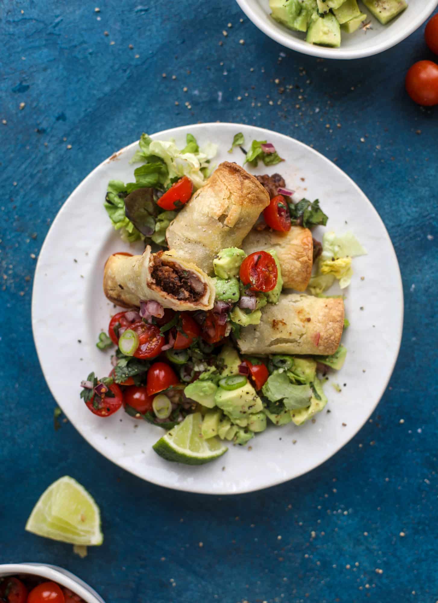 Saucy baked black bean taquitos have a crunchy outside and a creamy, flavorful inside. Served with a pico de gallo, they are an easy weeknight meal! I howsweeteats.com #baked #taquitos