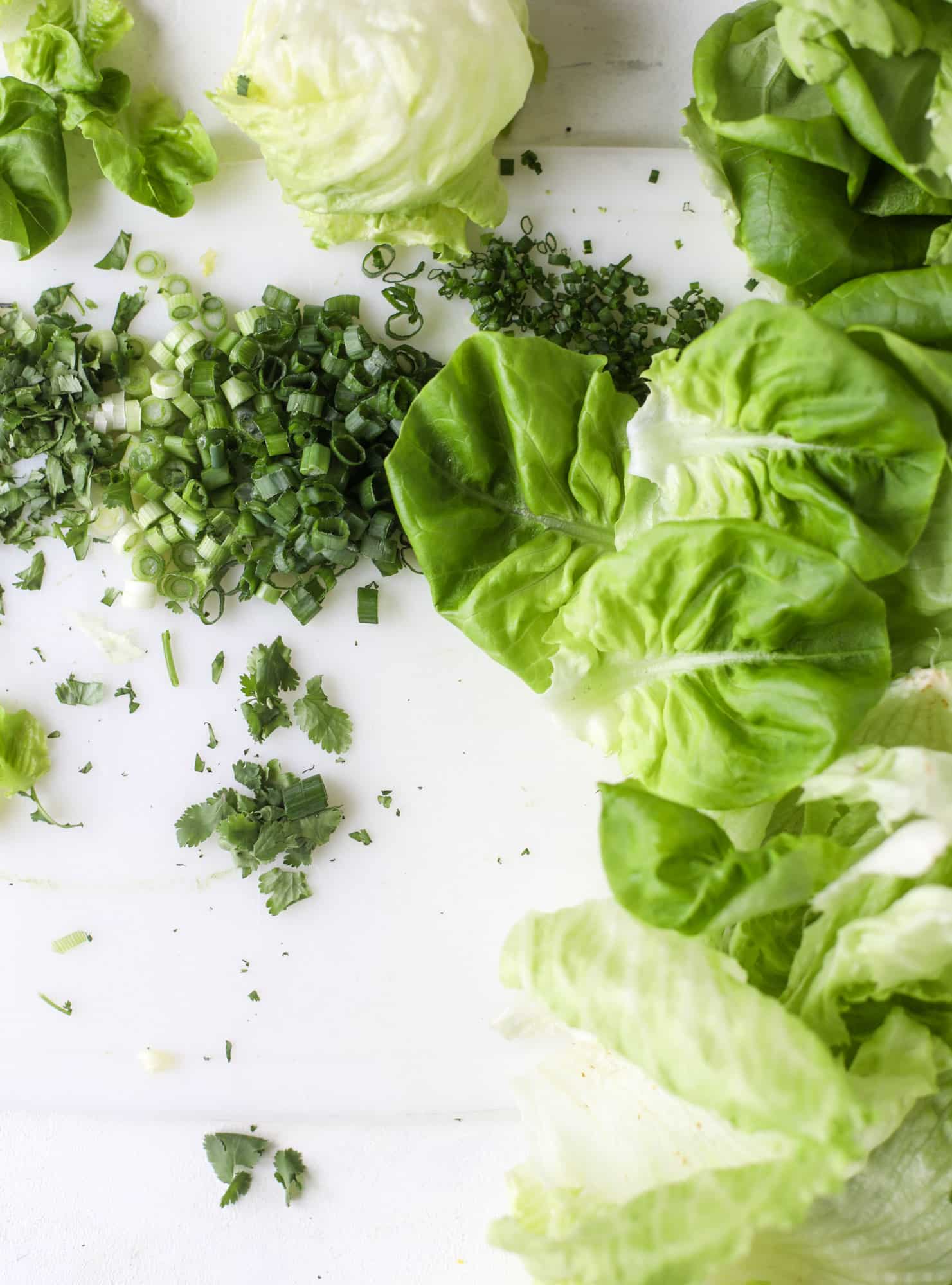 These buffalo cauliflower lettuce wraps are perfect for game day or even a quick weeknight dinner. Roasted cauliflower with buffalo wing sauce, sliced avocado, crumbled blue cheese, scallions, cilantro and chives makes for a flavor explosion! I howsweeteats.com #buffalo #cauliflower
