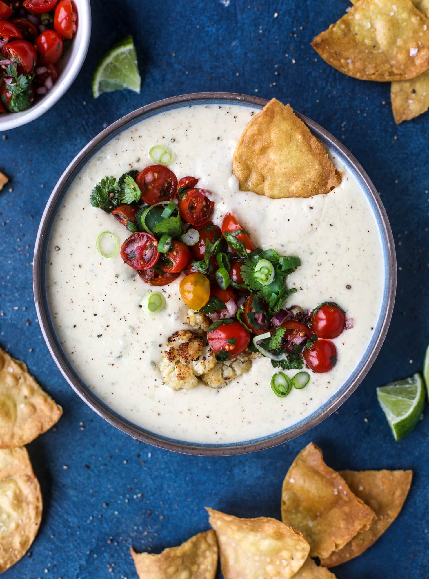 This roasted cauliflower queso has all the deliciousness of regular queso, with roasted cauliflower added in. It's satisfying and tastes like heaven. I howsweeteats.com #cauliflower #queso