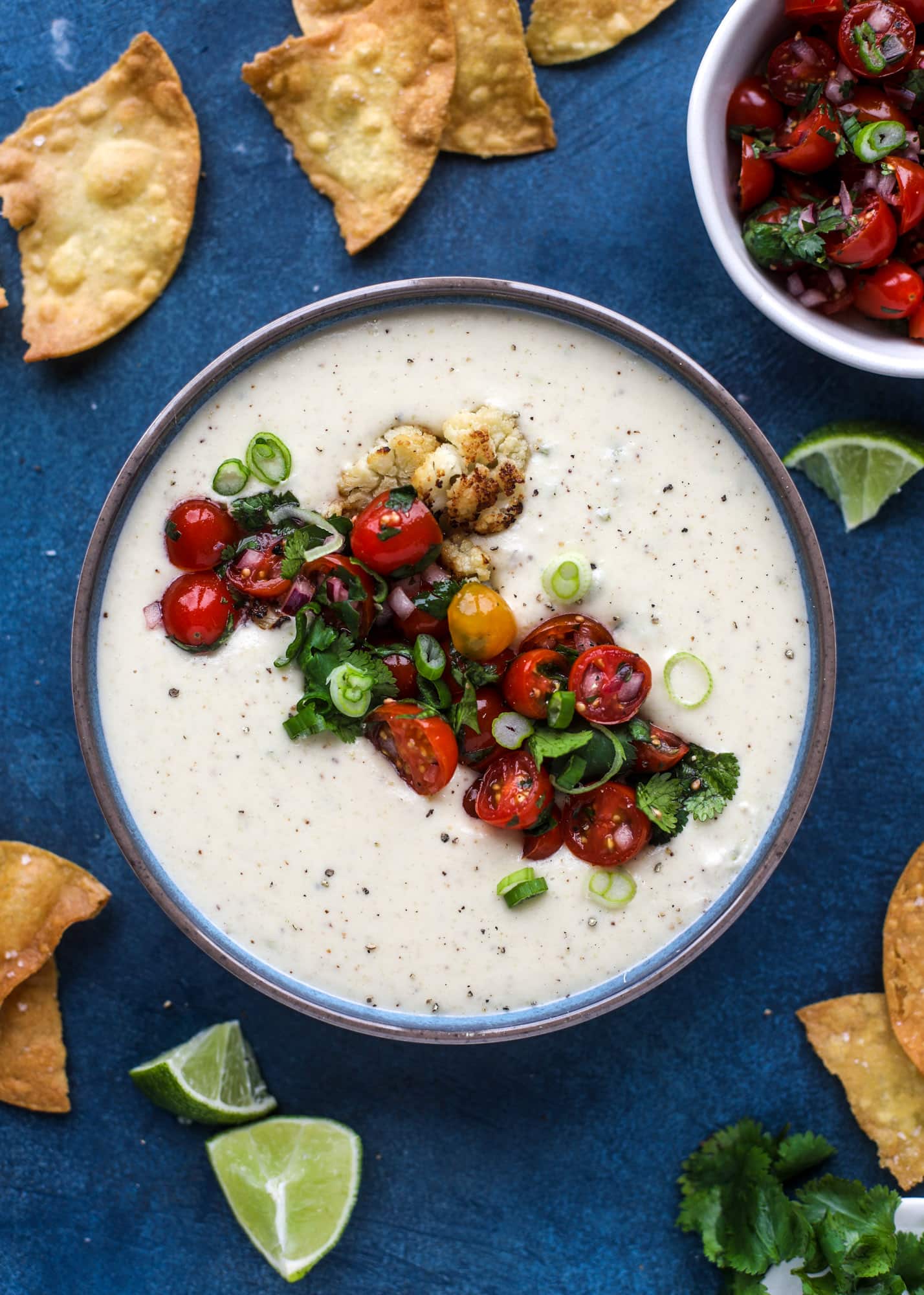 This roasted cauliflower queso has all the deliciousness of regular queso, with roasted cauliflower added in. It's satisfying and tastes like heaven. I howsweeteats.com #cauliflower #queso