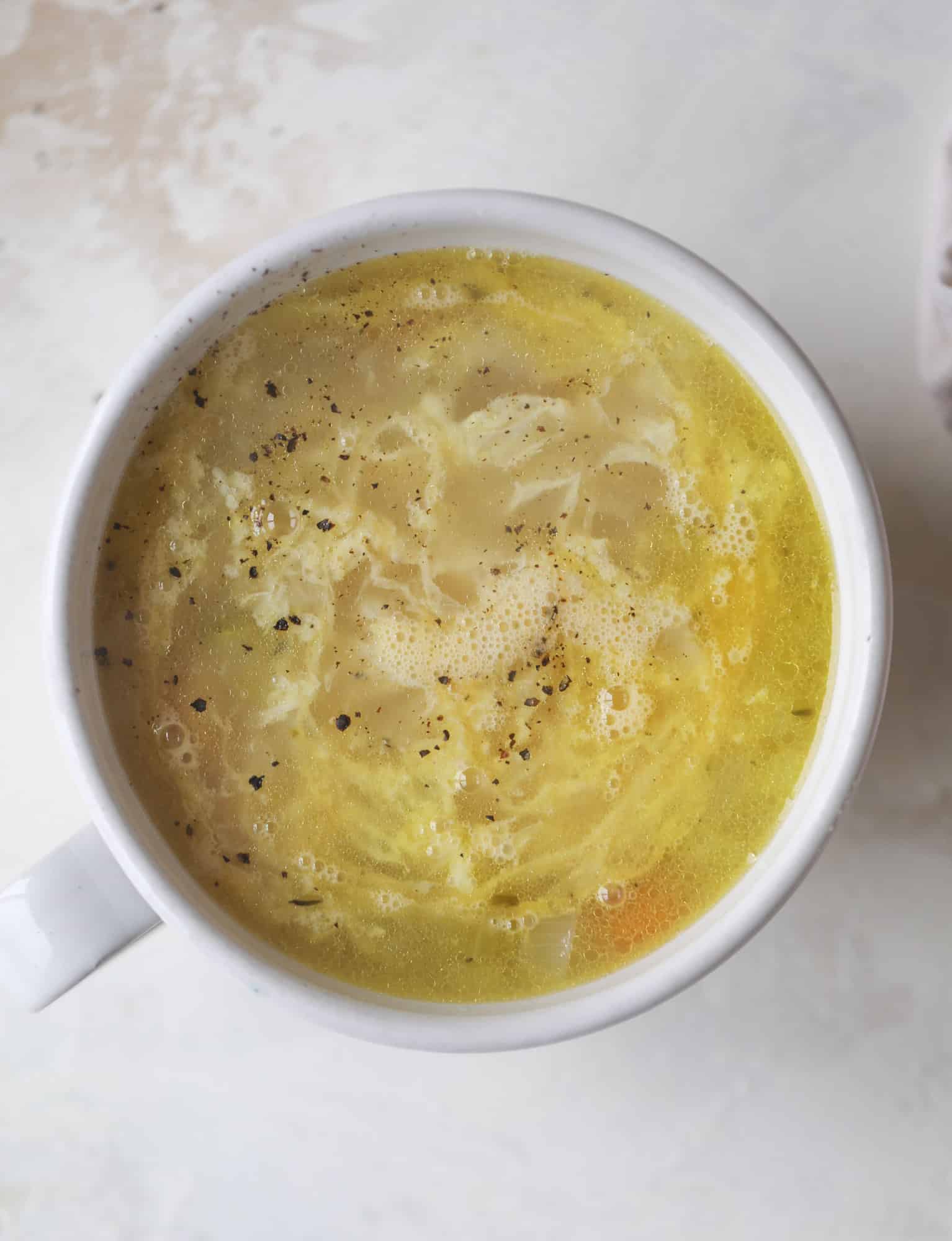 This chicken noodle egg drop soup is the ultimate comfort food! Homemade stock and satisfying ingredients provide the best nourishment and comfort! I howsweeteats.com #chicken #noodlesoup